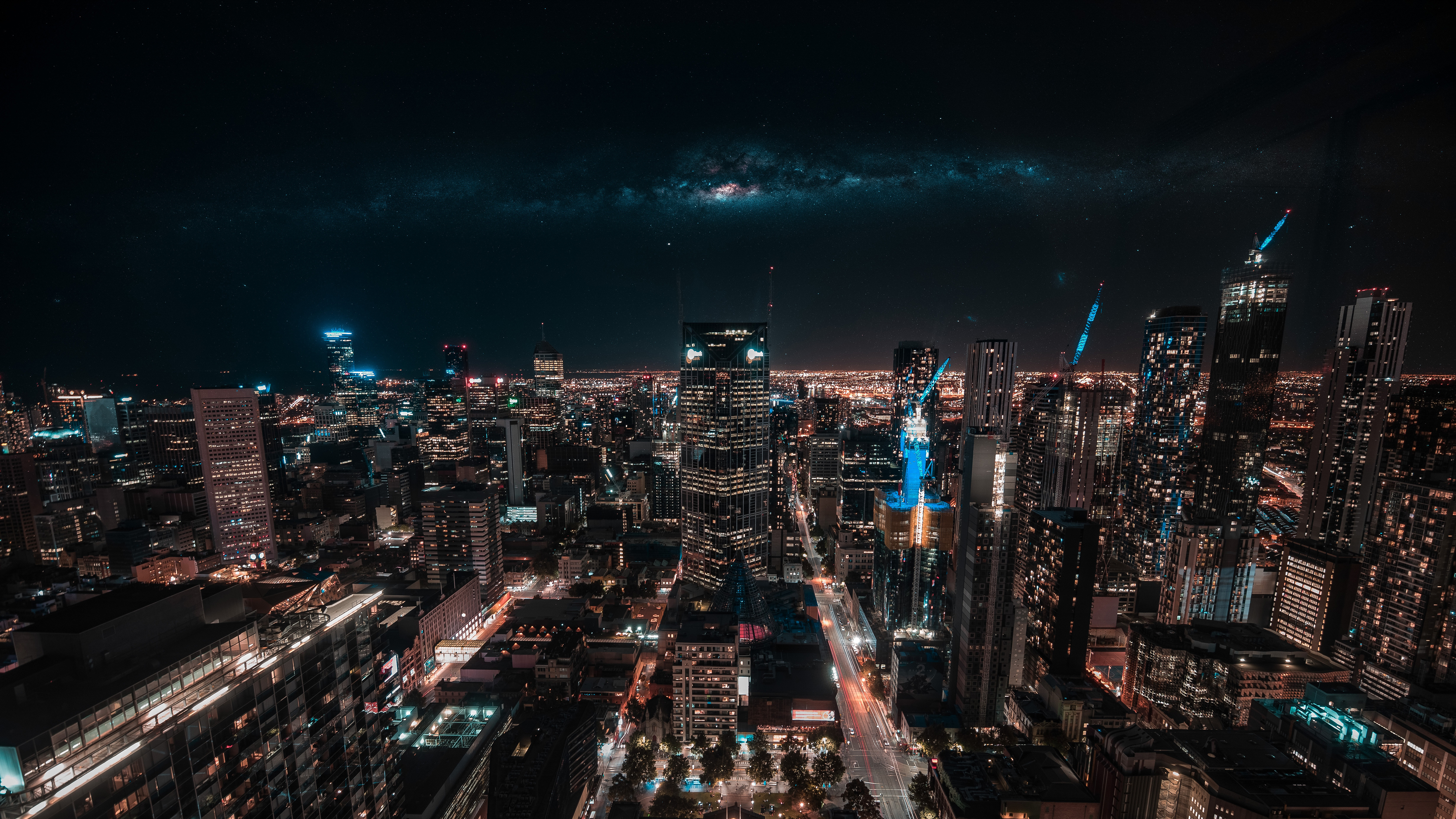Cityscape at Night with Milky Way Galaxy Above HD Wallpaper