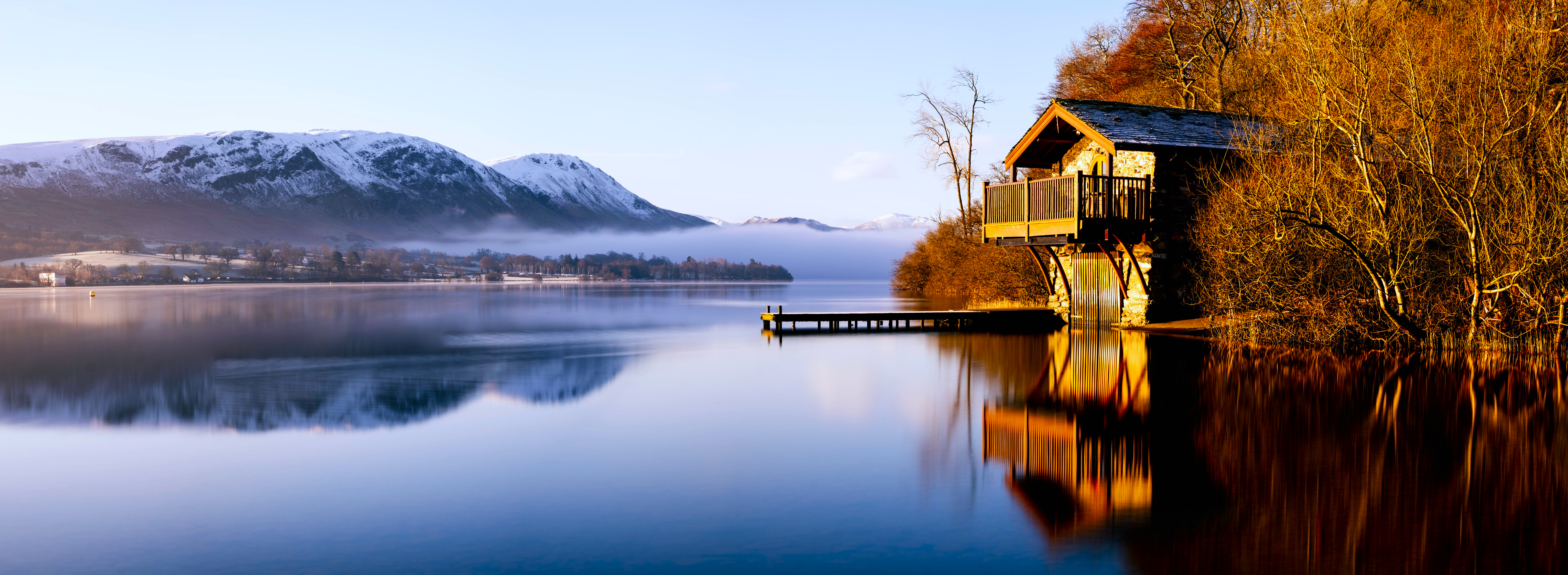 House on a lake with mountains and mist at sunrise HD Wallpaper