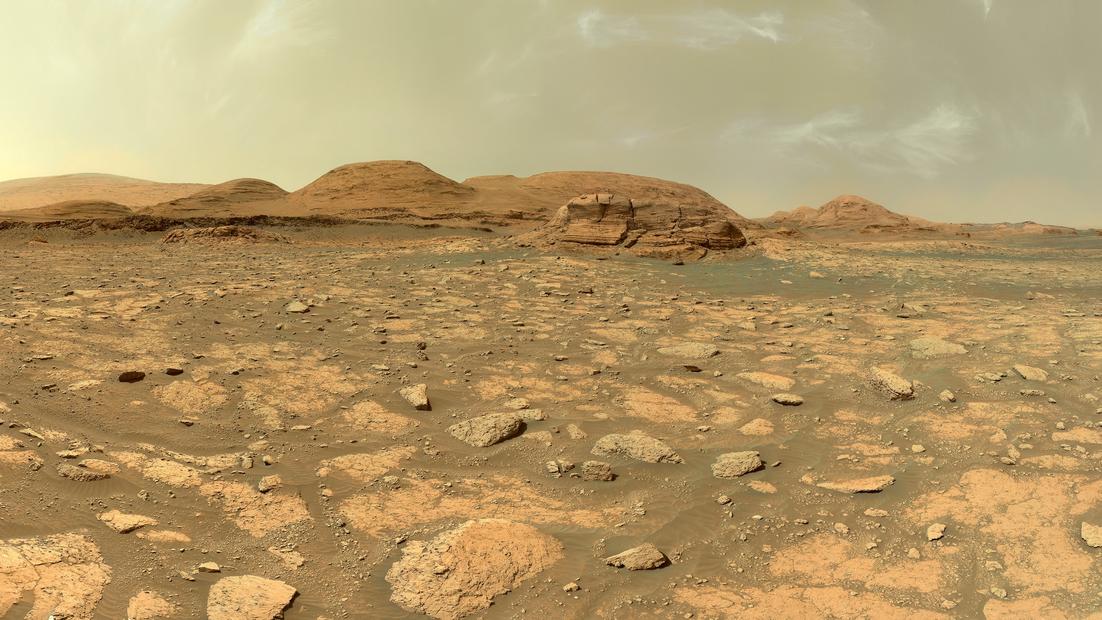 Mars landscape with rocky terrain and hills under a dusty sky HD Wallpaper