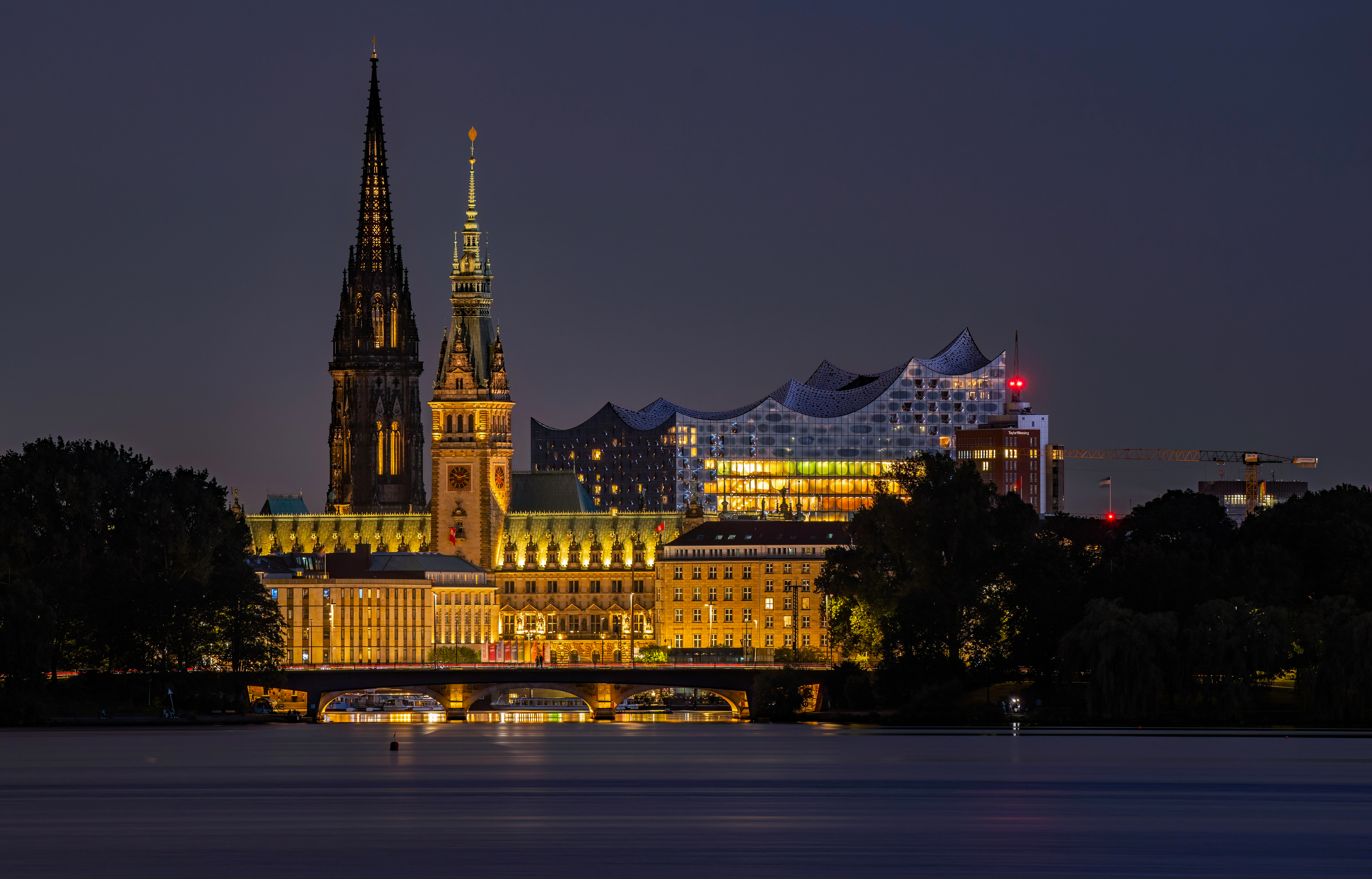 City skyline with illuminated buildings and bridge at night HD Wallpaper