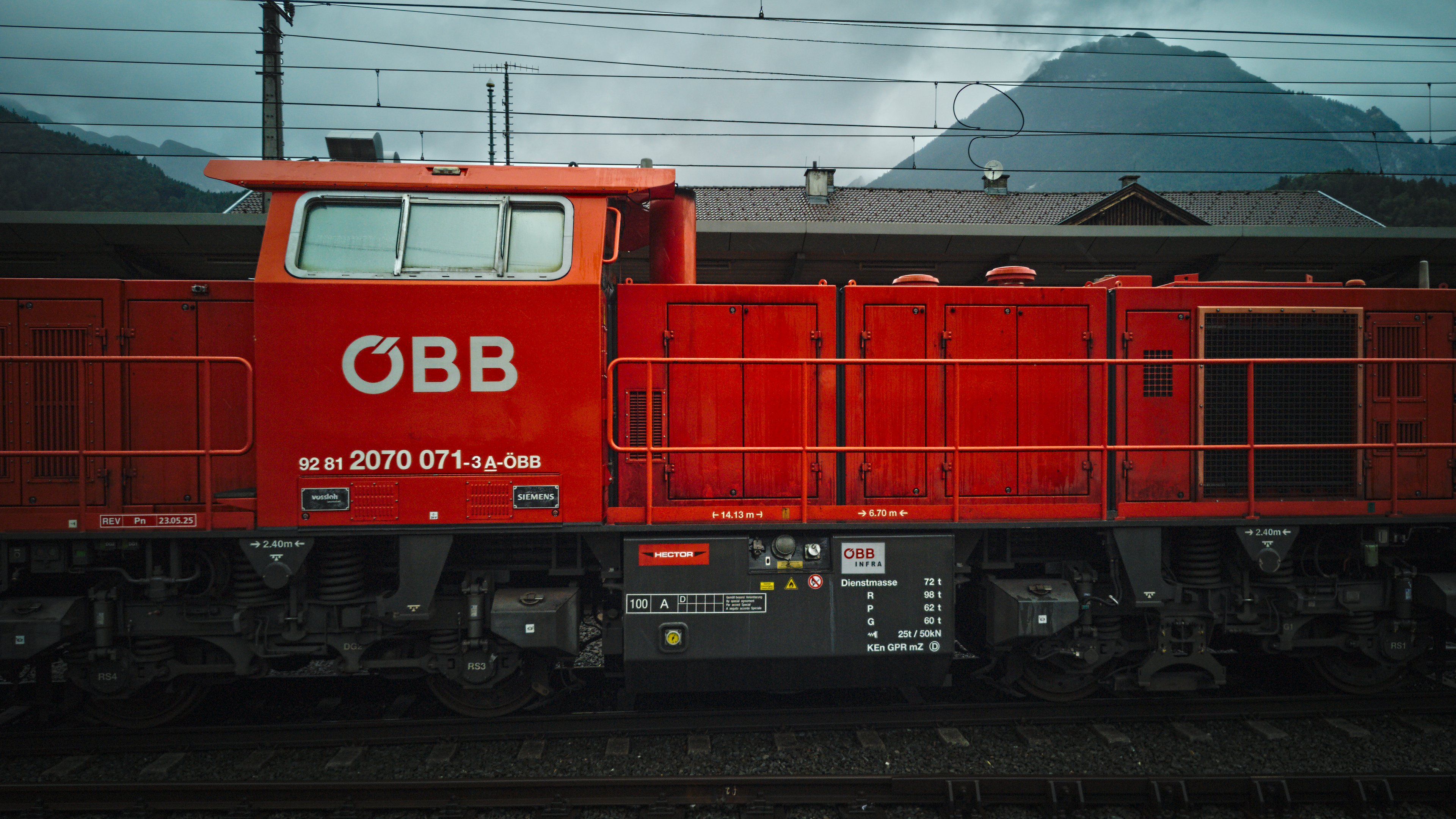 Red ÖBB 2070 diesel locomotive at a train station HD Wallpaper