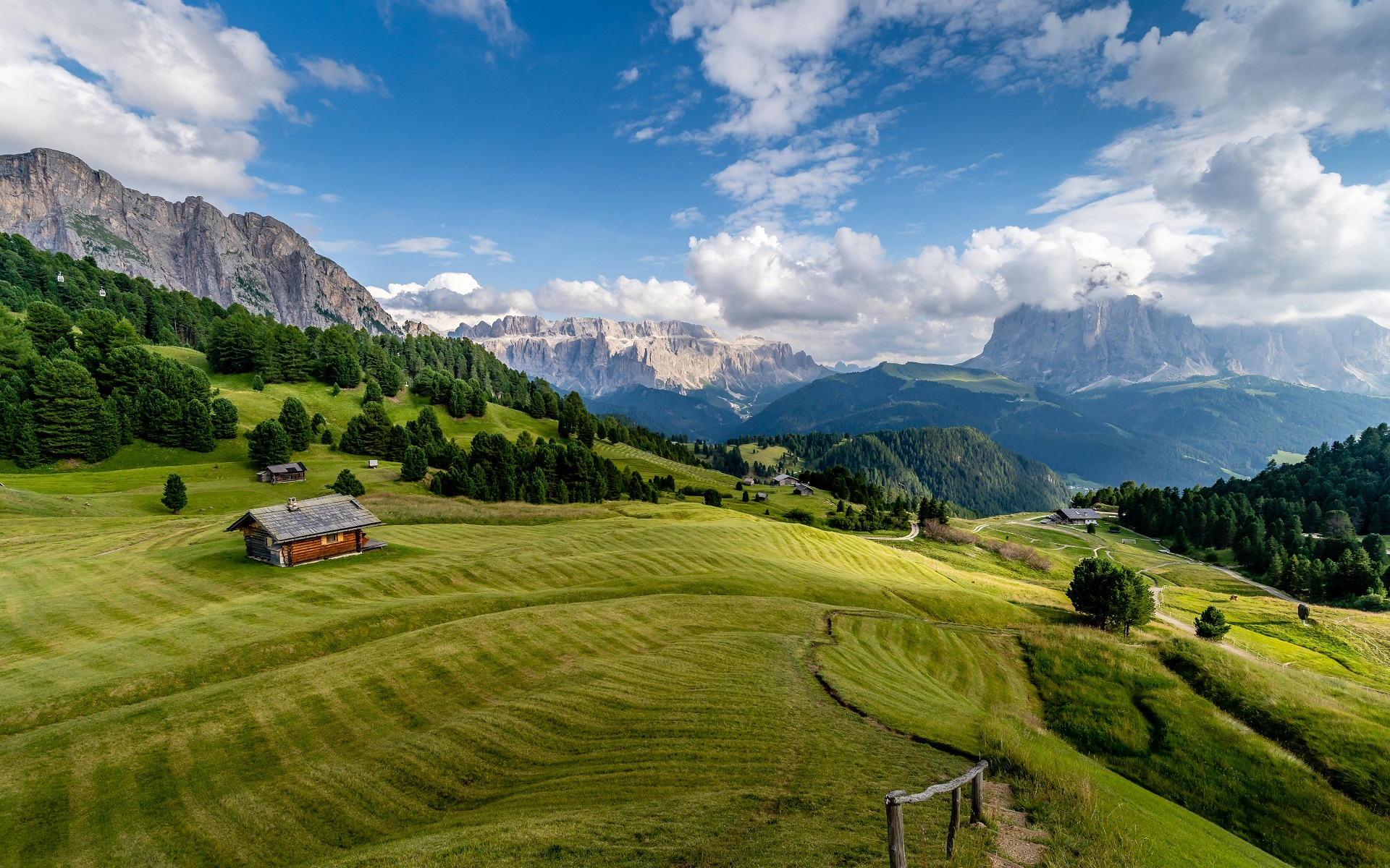 Green mountain landscape with wooden cabin and cloudy sky HD Wallpaper