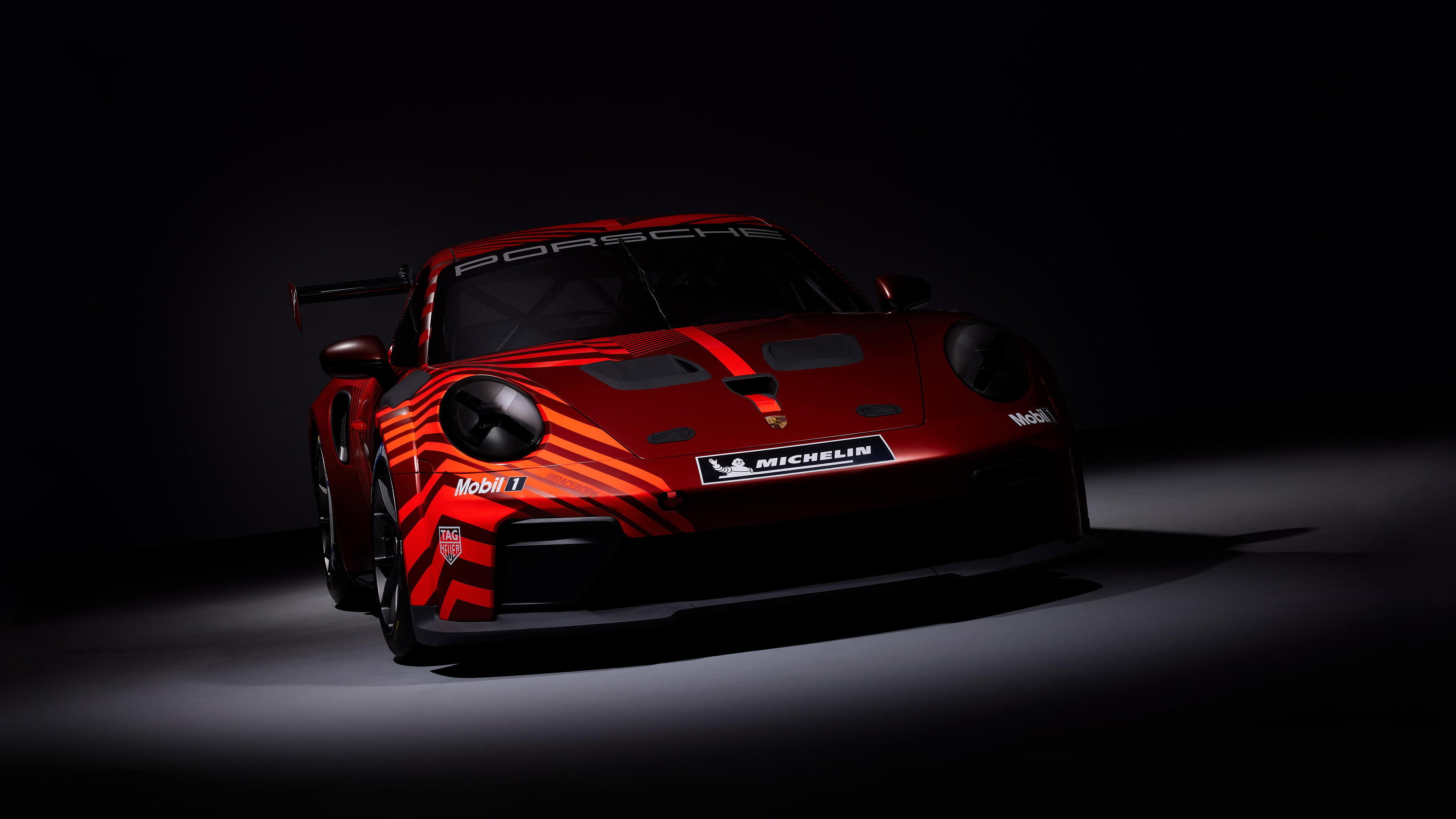 Red Porsche race car with racing decals HD Wallpaper