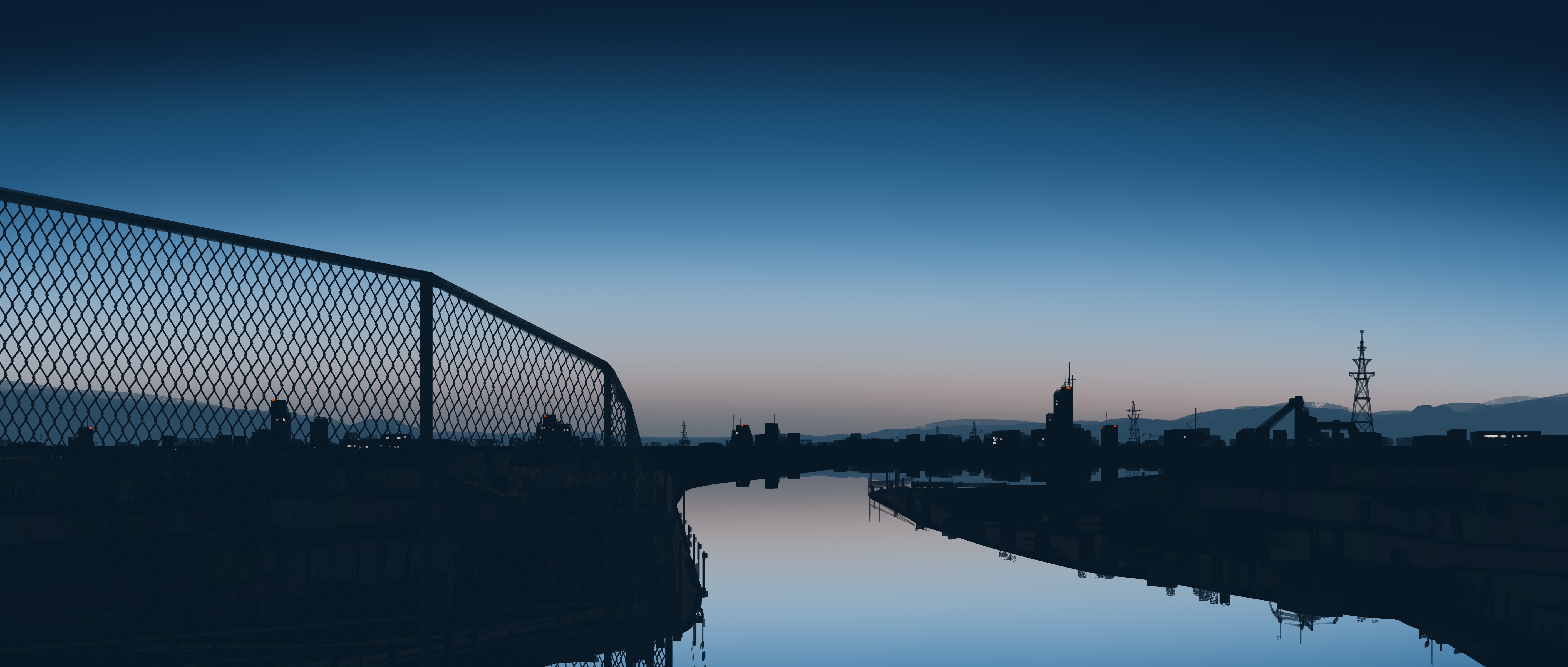 City skyline reflected in a river at dusk HD Wallpaper