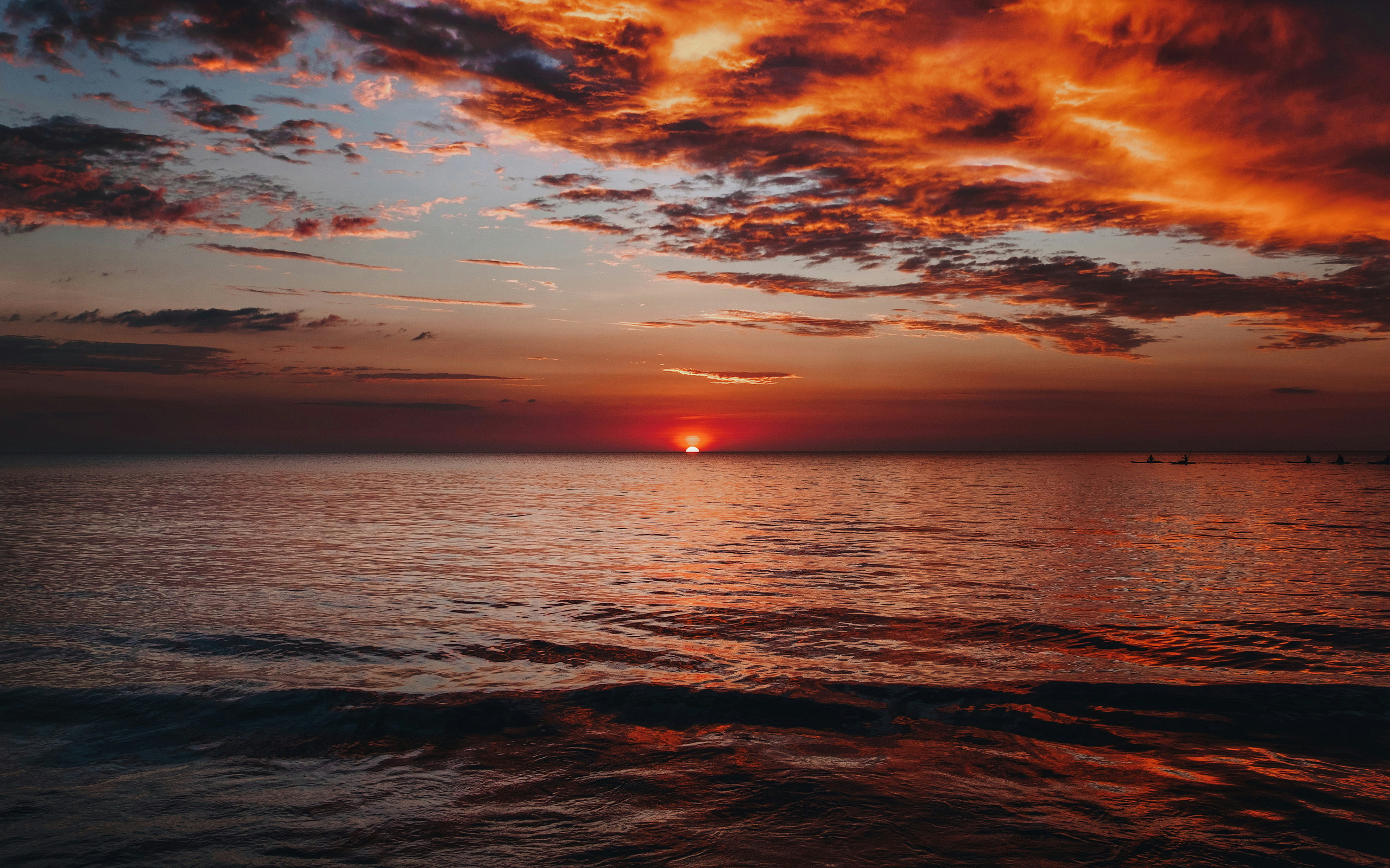 Boat on the sea during a vibrant sunset HD Wallpaper