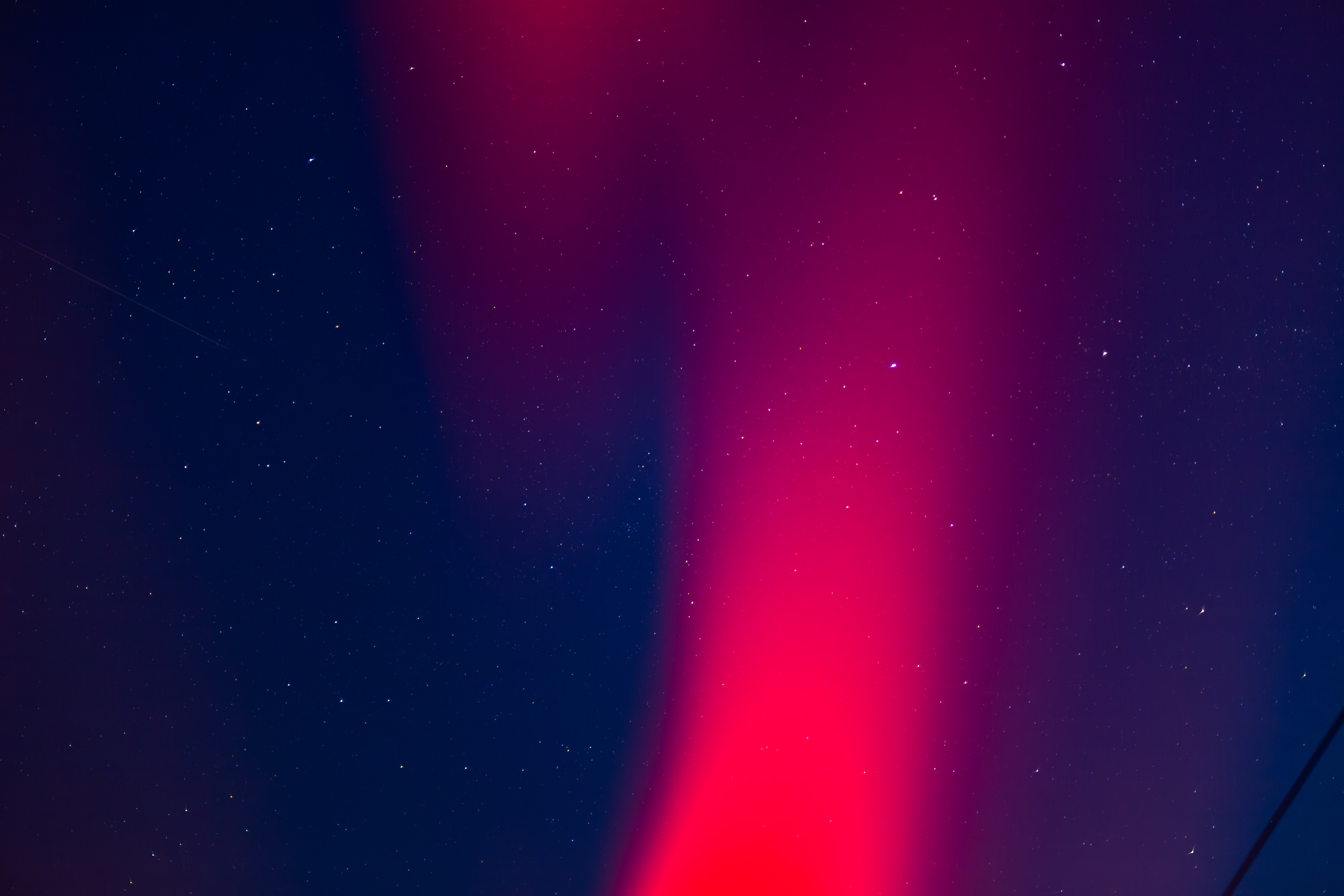 Red aurora borealis in a starry night sky HD Wallpaper