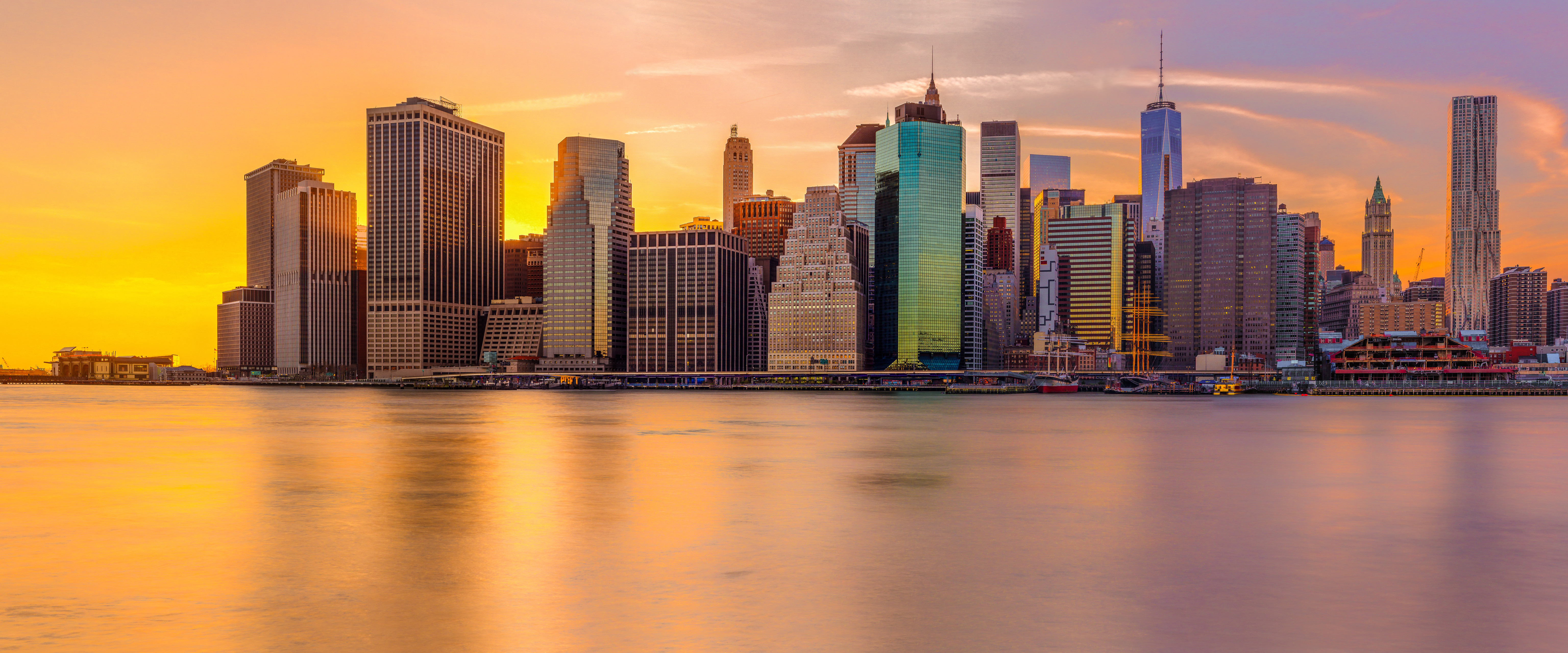 New York City skyline at sunset over the water HD Wallpaper