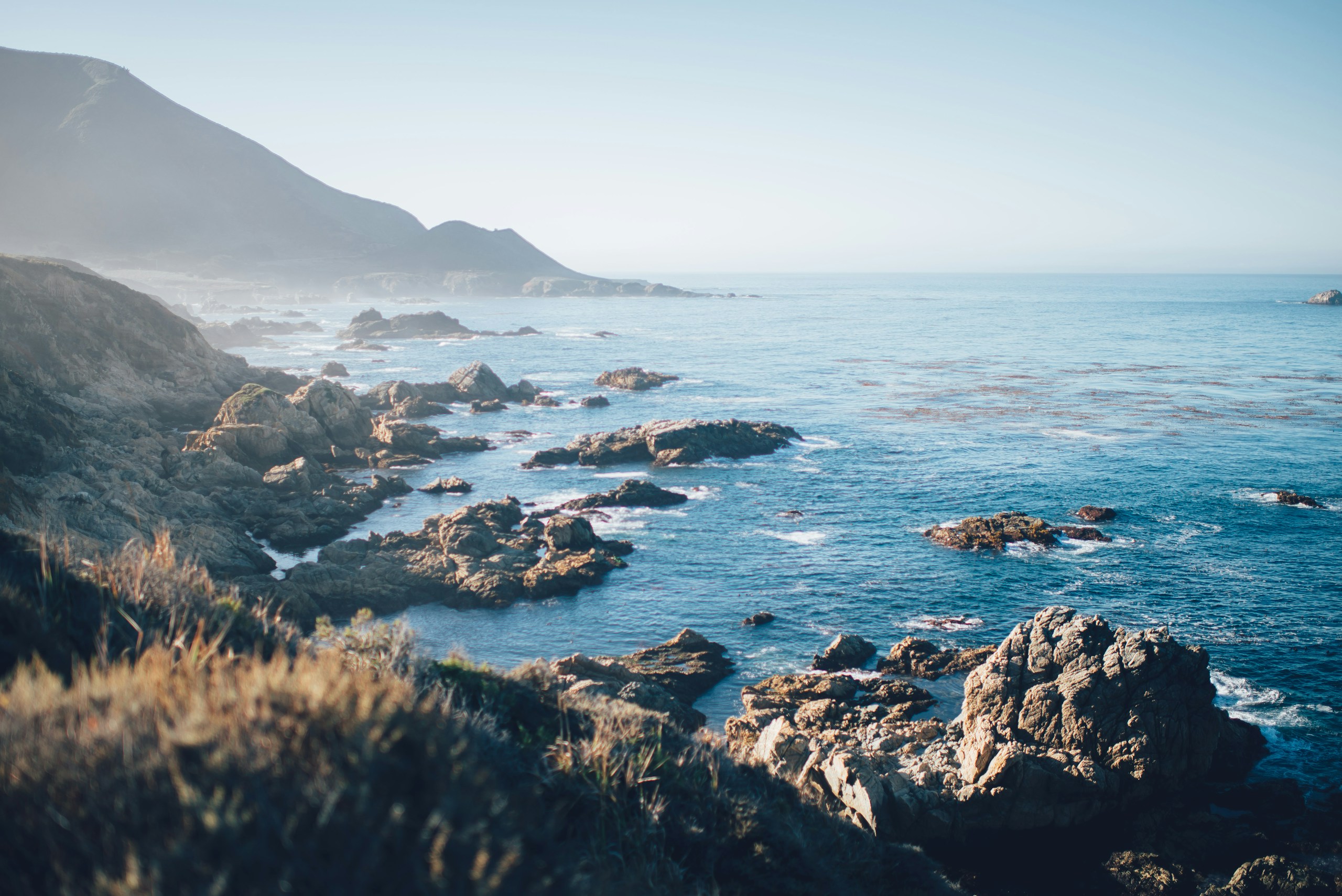 Rocky Coastline and Mountains by the Ocean HD Wallpaper