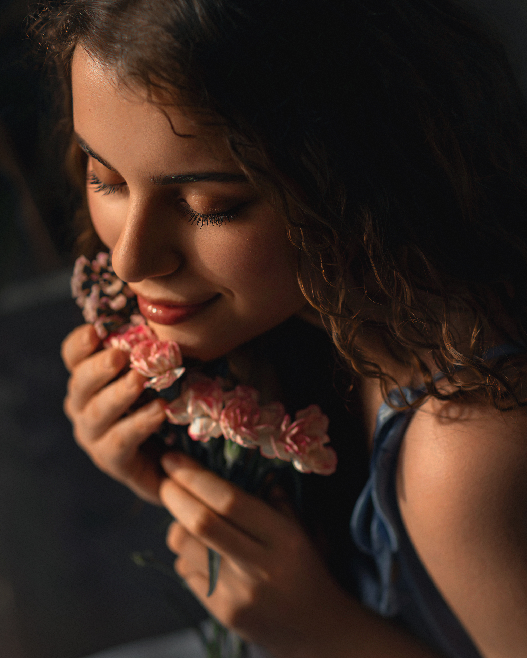 Young Woman Smiling and Smelling Pink Flowers HD Wallpaper