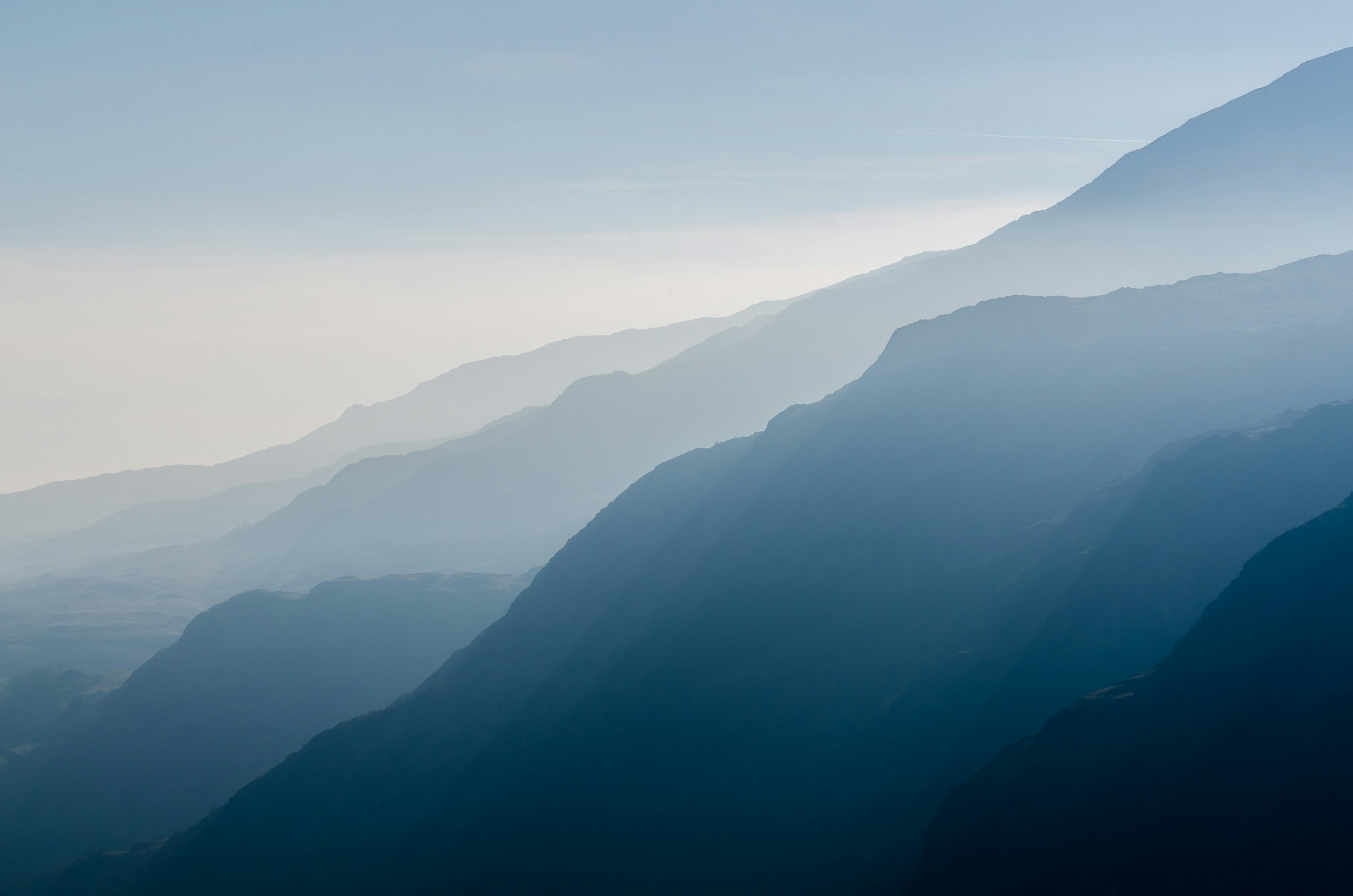 Hazy blue mountain ridges fading into the distance HD Wallpaper