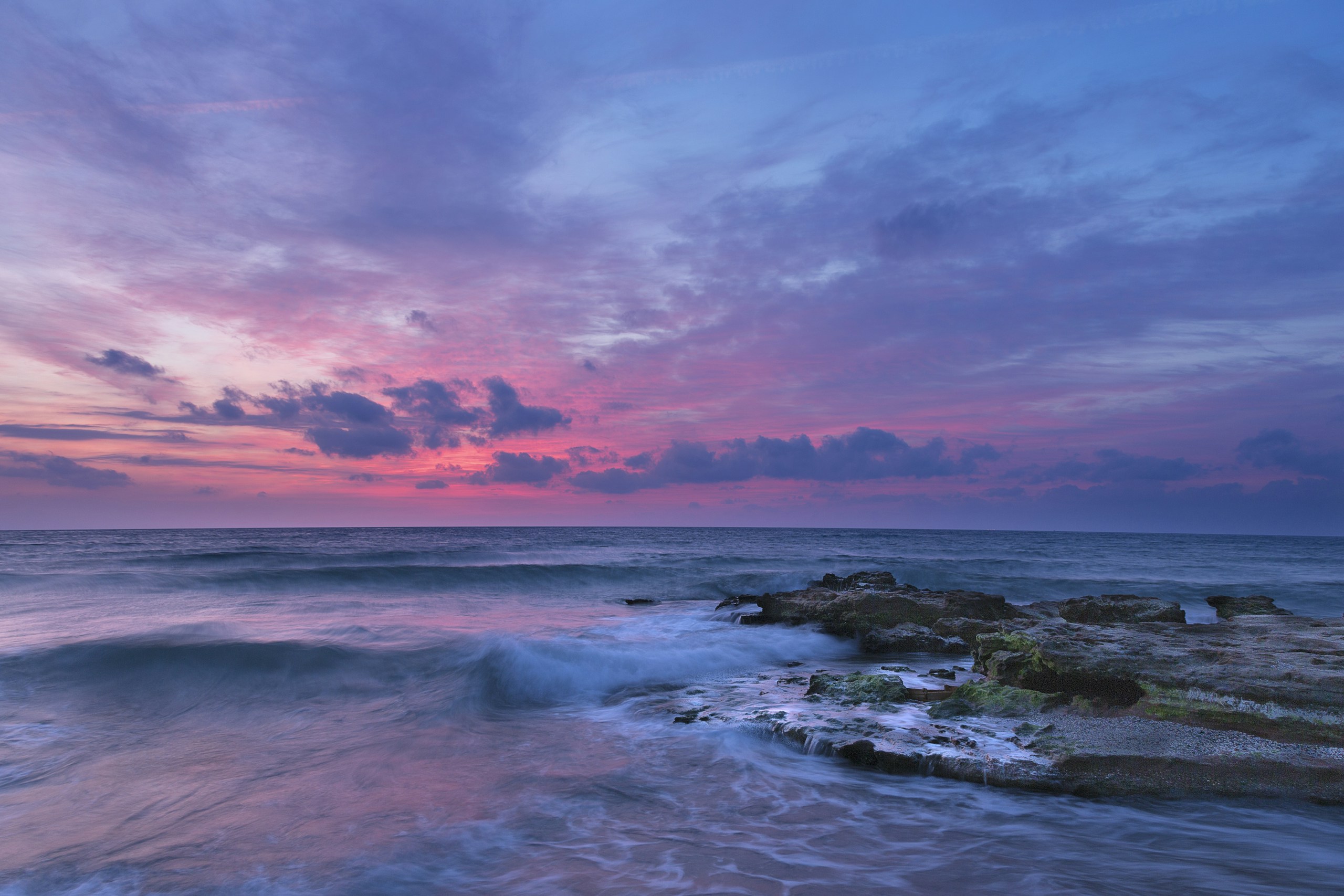 Rocky Coastline with Waves Under Purple Sunset Sky HD Wallpaper