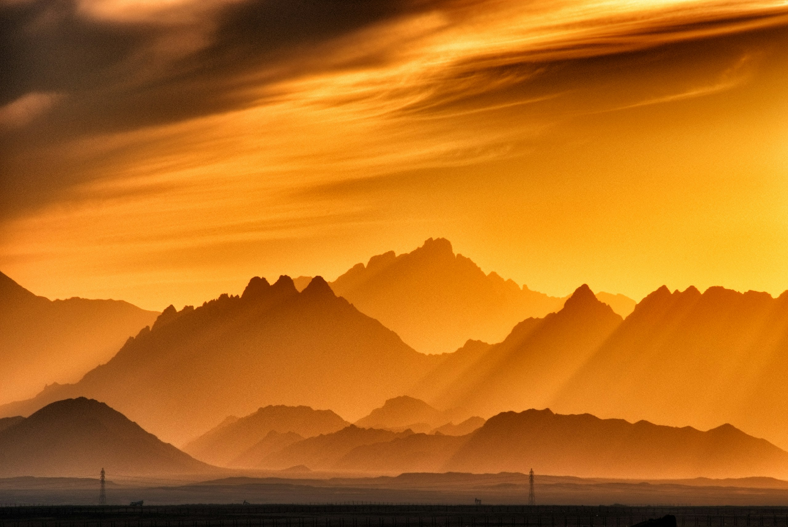 Golden Sunset Over Layered Mountain Ranges HD Wallpaper