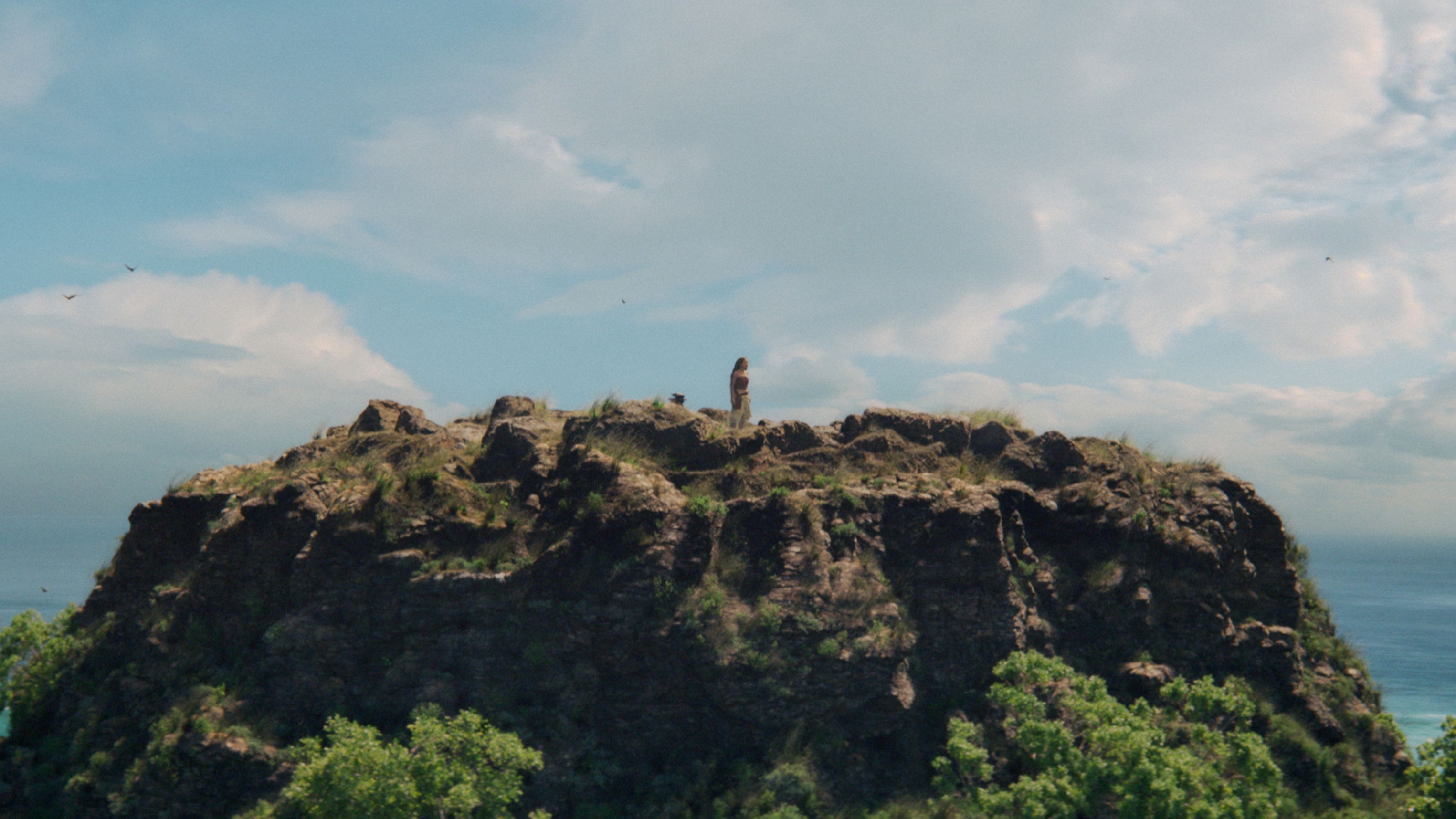Moana standing on a rocky cliff HD Wallpaper
