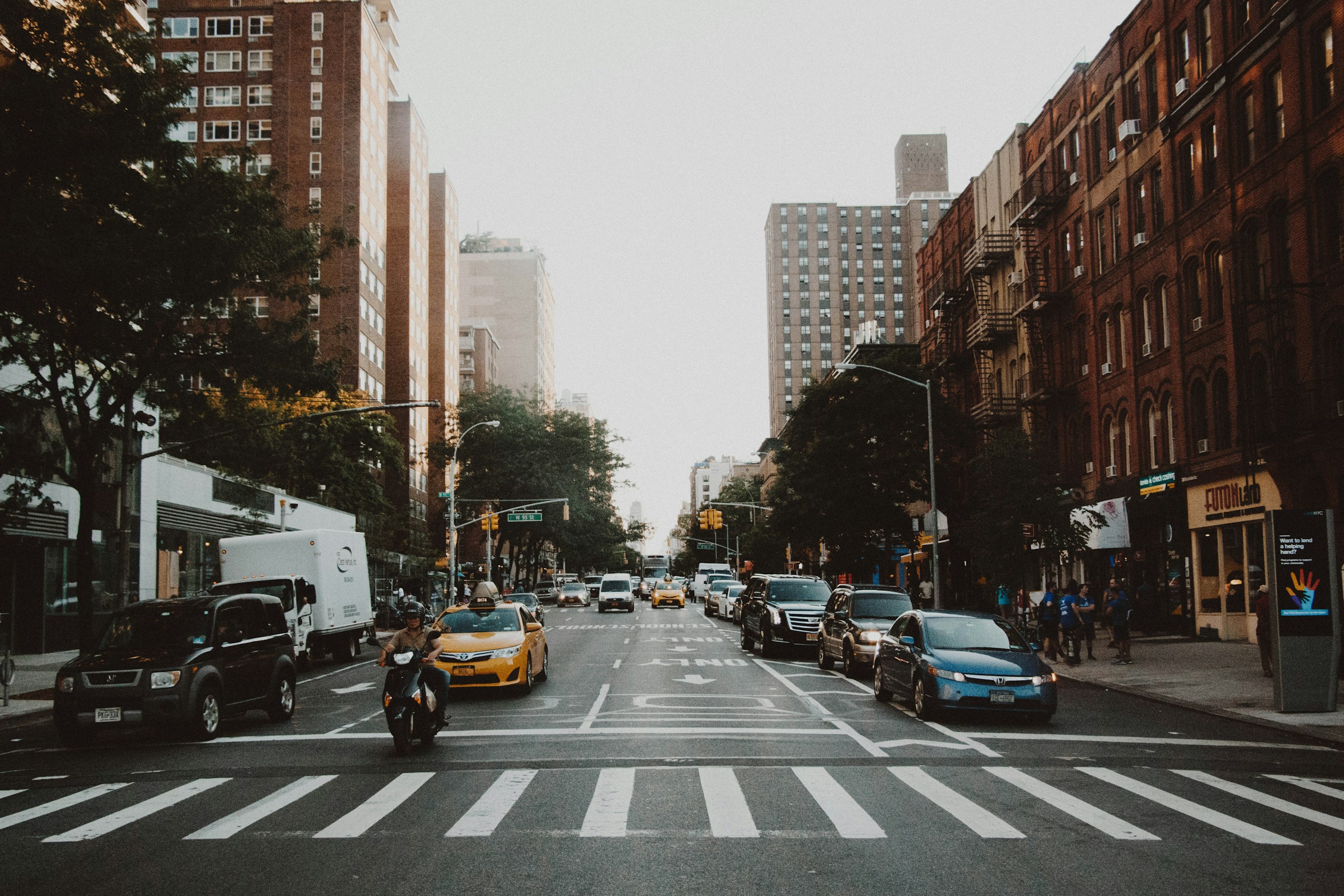 Traffic and buildings on a New York City street HD Wallpaper