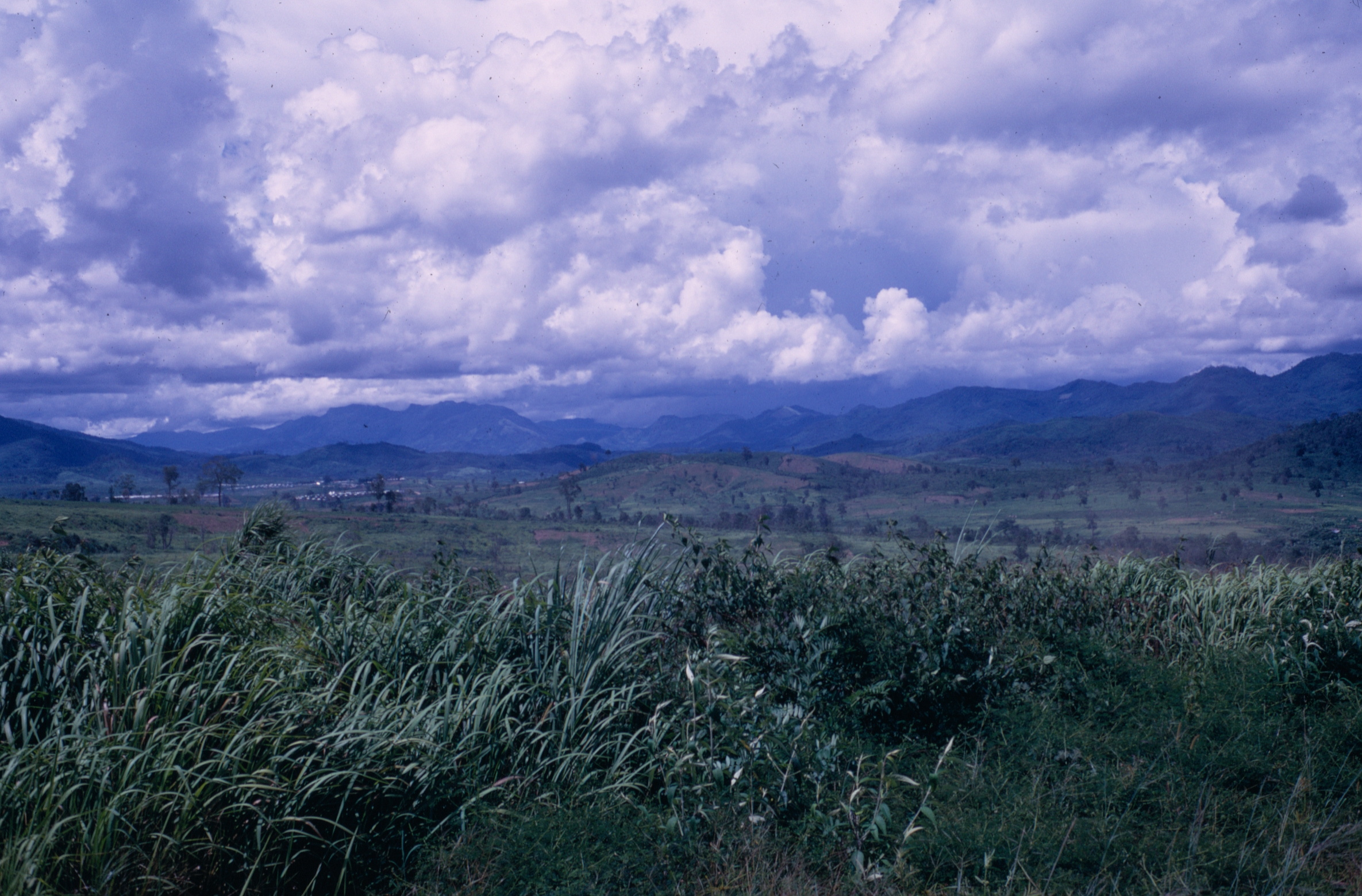 Lush Green Hills and Mountains under Cloudy Sky HD Wallpaper