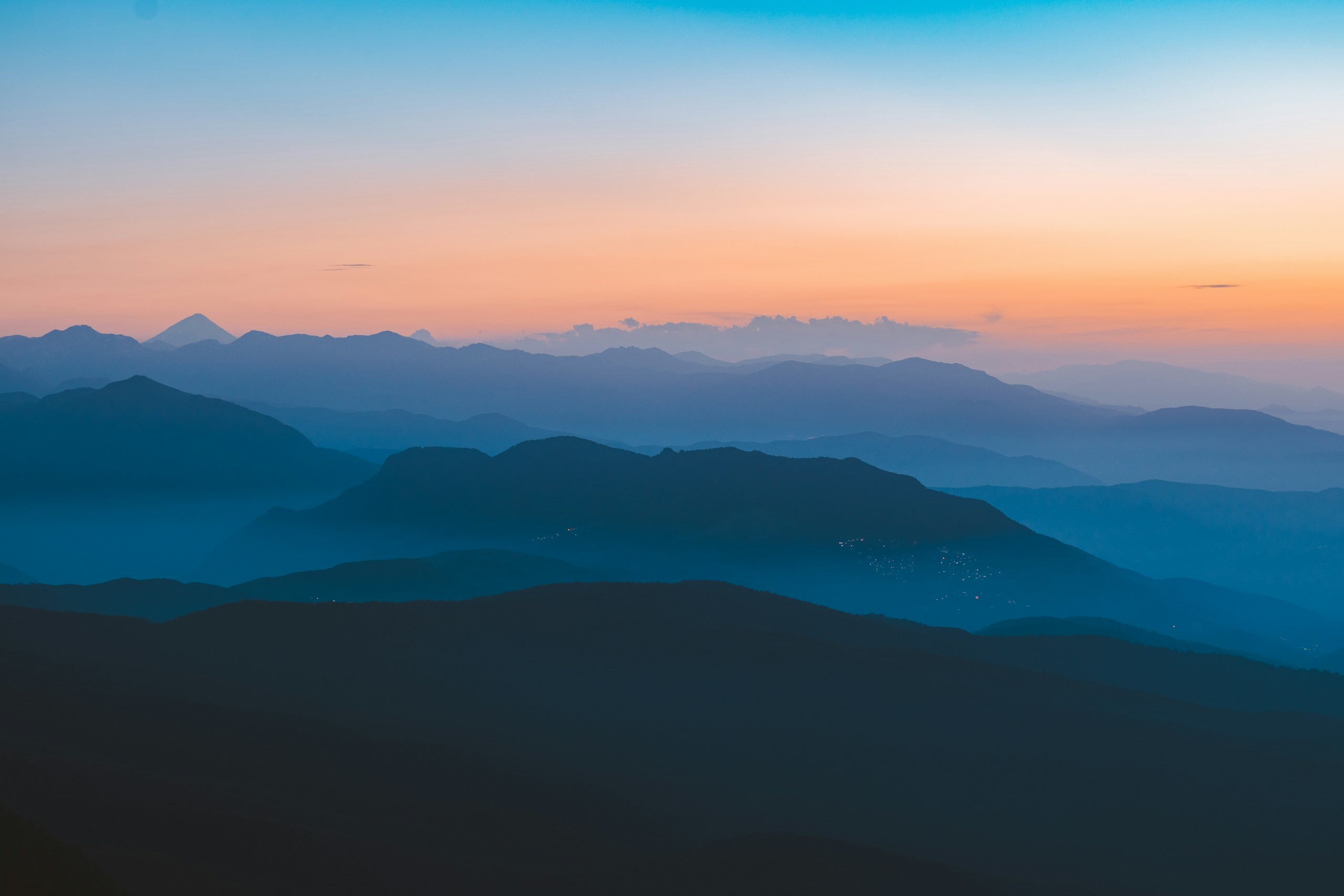 Blue mountain ridges under a sunset sky HD Wallpaper