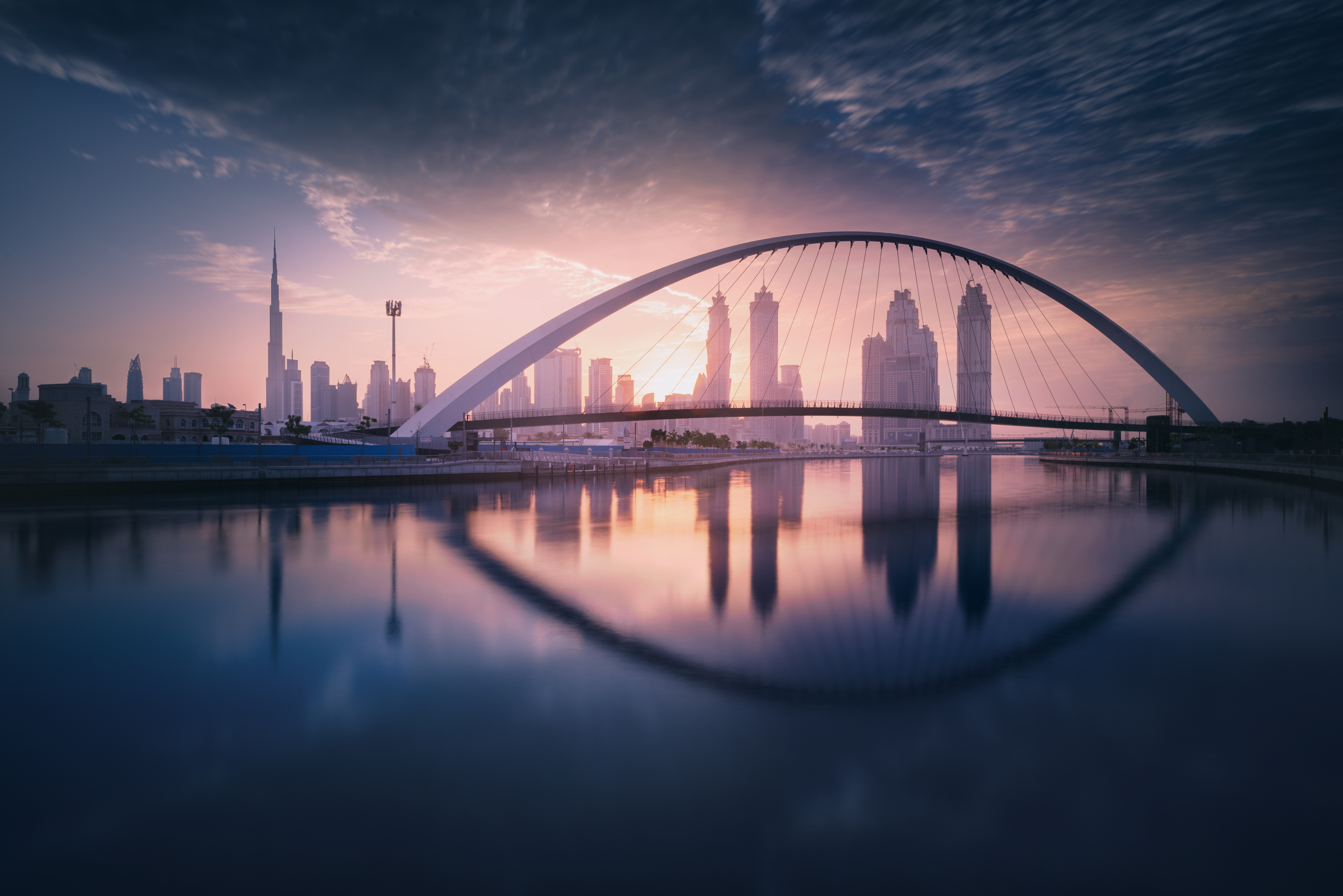 Dubai Tolerance Bridge and Skyline Reflection at Sunset HD Wallpaper