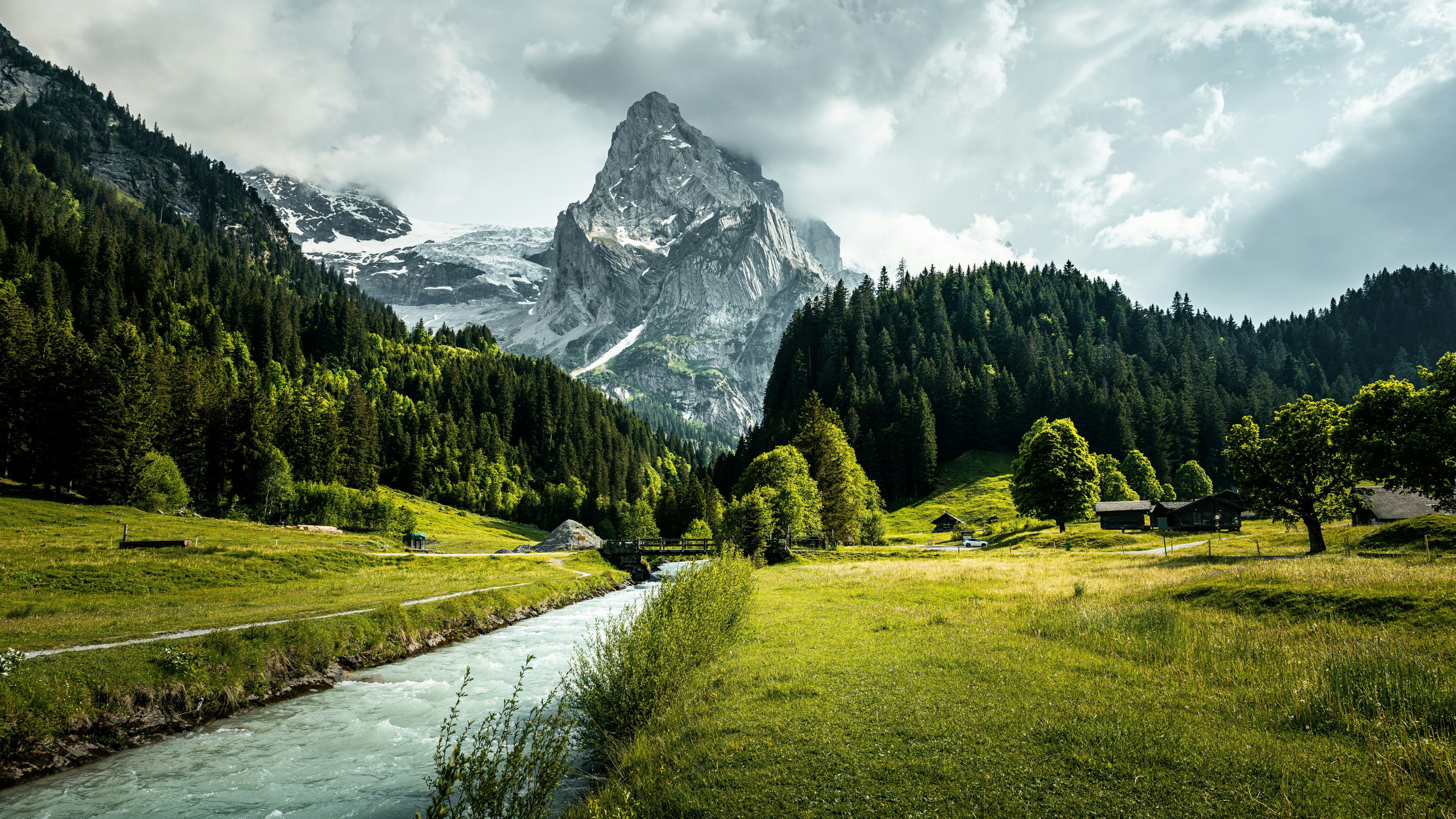 Rocky mountain peak with river flowing through green valley HD Wallpaper