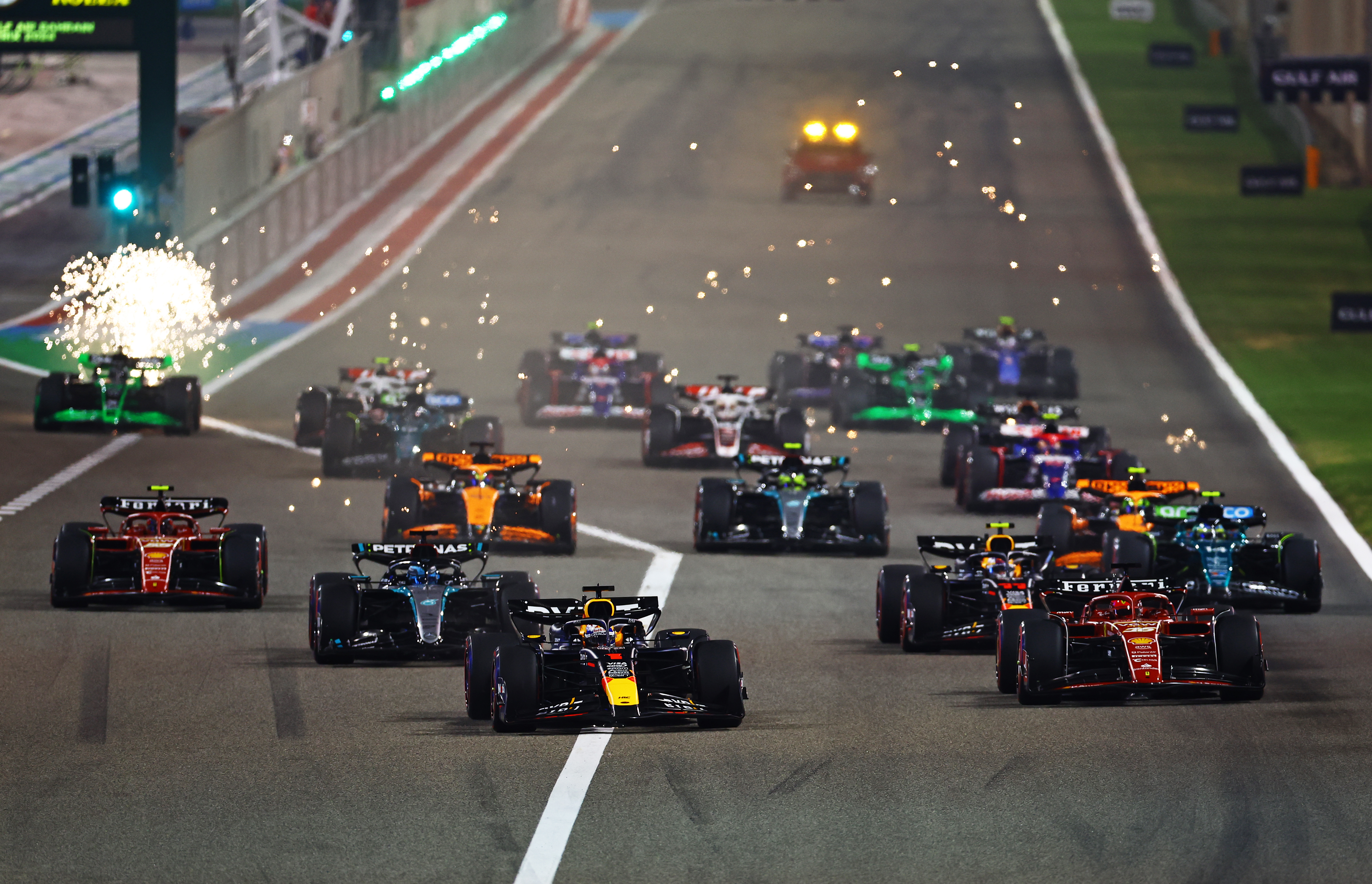 Formula 1 Cars Racing on Track at Night HD Wallpaper