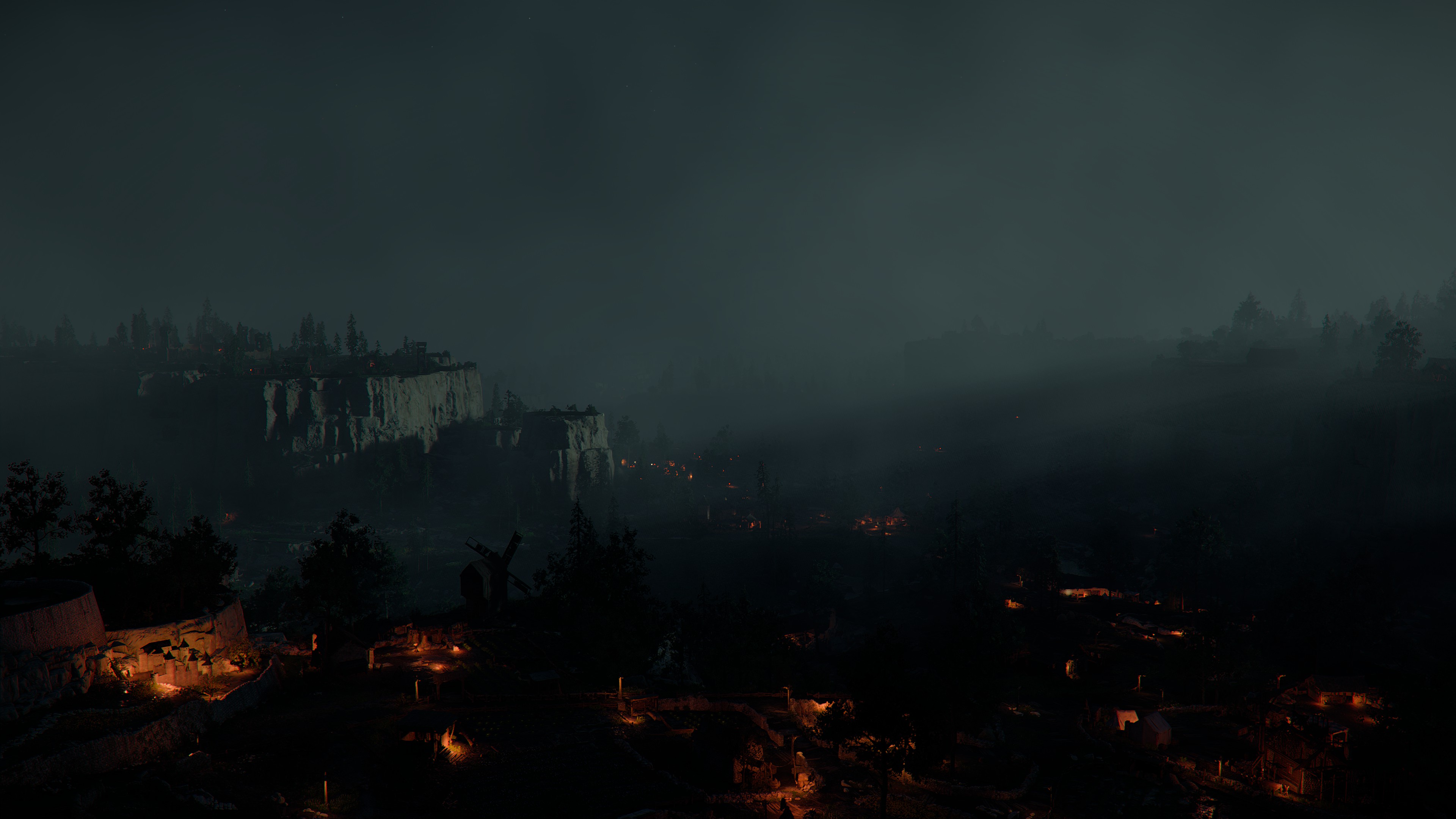 Dark misty valley with scattered lights at night HD Wallpaper