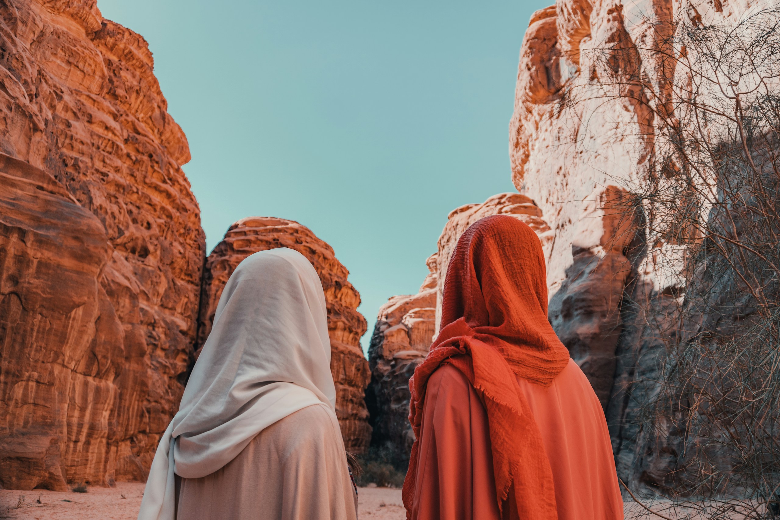 Two women in headscarves standing in Hisma Desert canyon HD Wallpaper