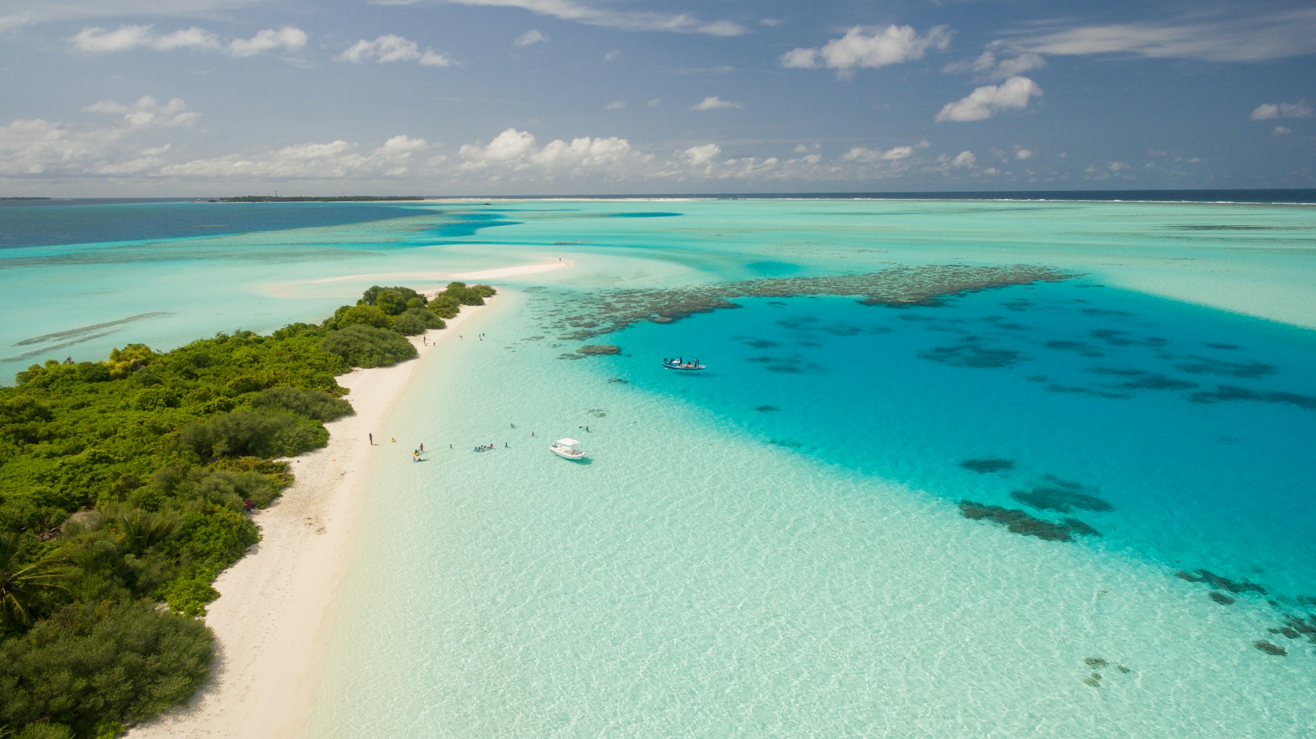 Aerial view of a tropical beach and turquoise lagoon HD Wallpaper