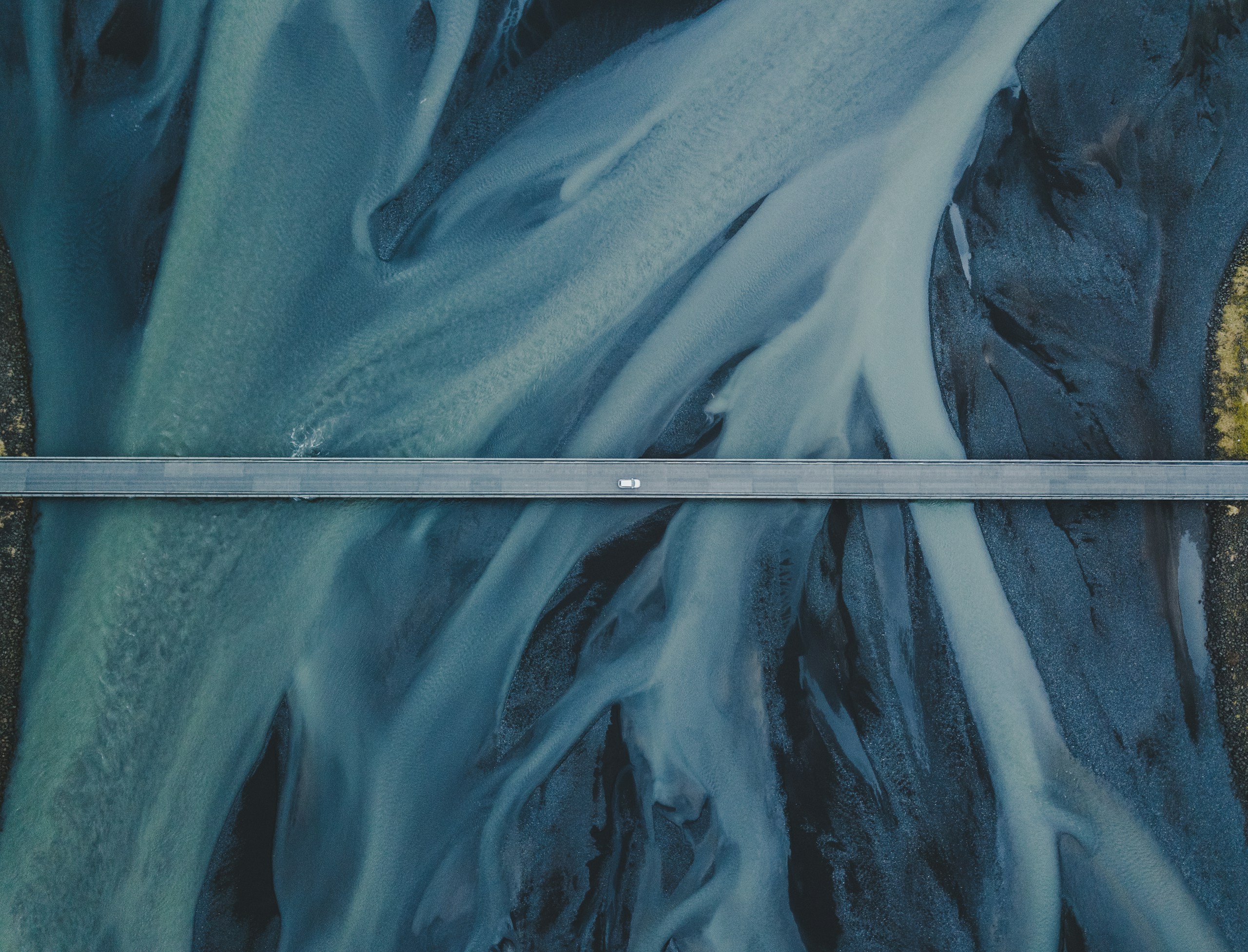 Aerial view of a bridge over a braided river HD Wallpaper