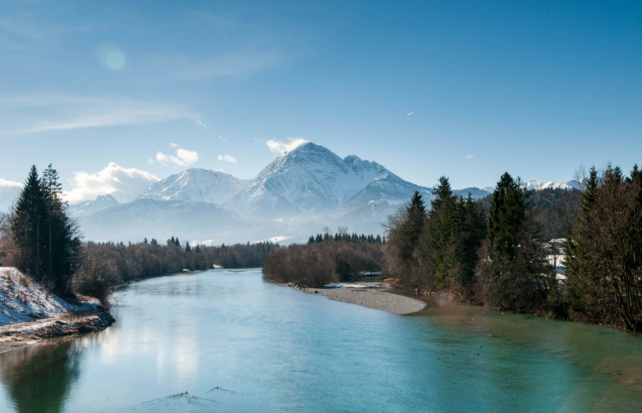Calm river flowing towards snow-covered mountains HD Wallpaper