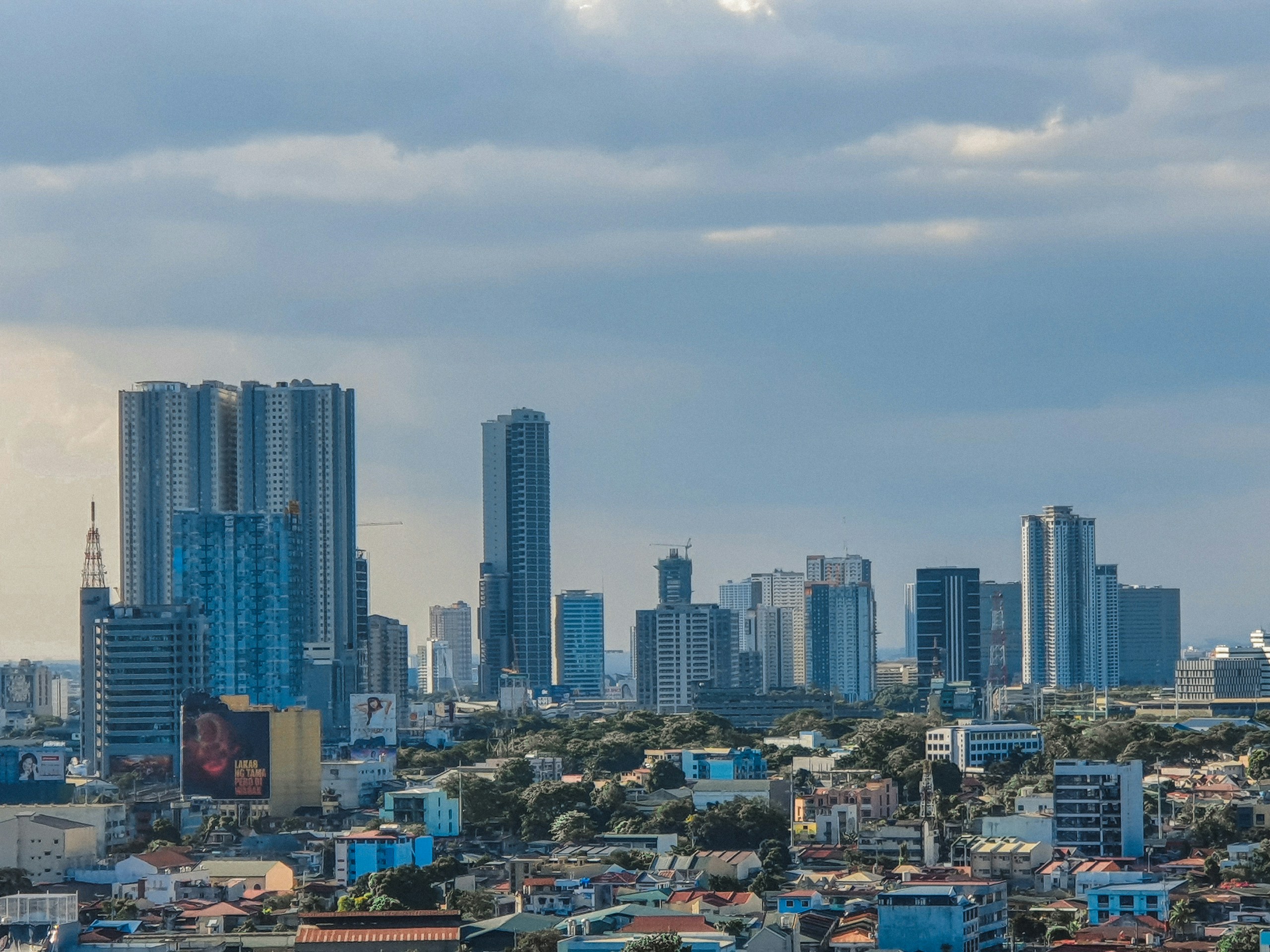 High Rise City Skyline Under Cloudy Sky HD Wallpaper
