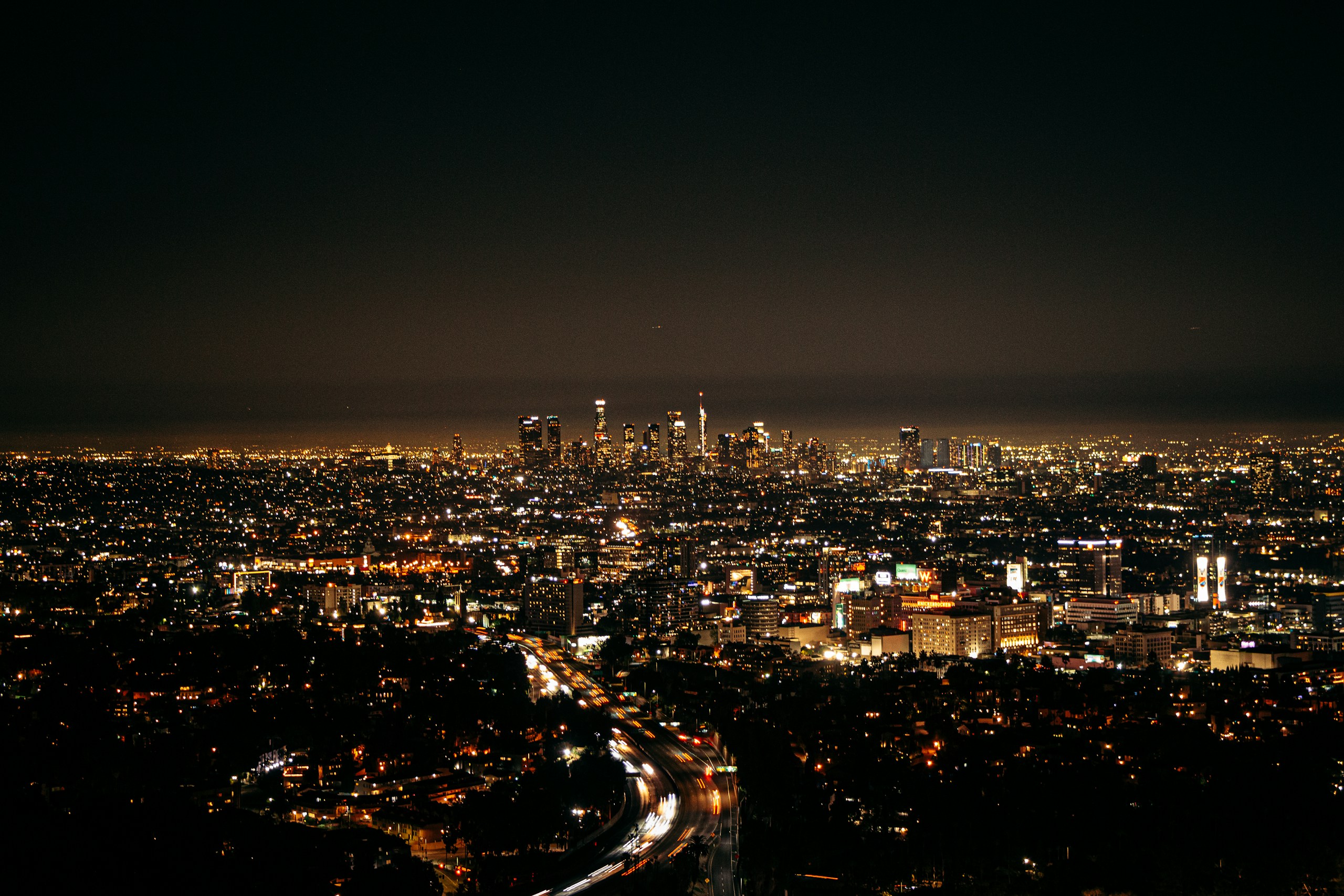 Night view of Los Angeles skyline and freeway HD Wallpaper