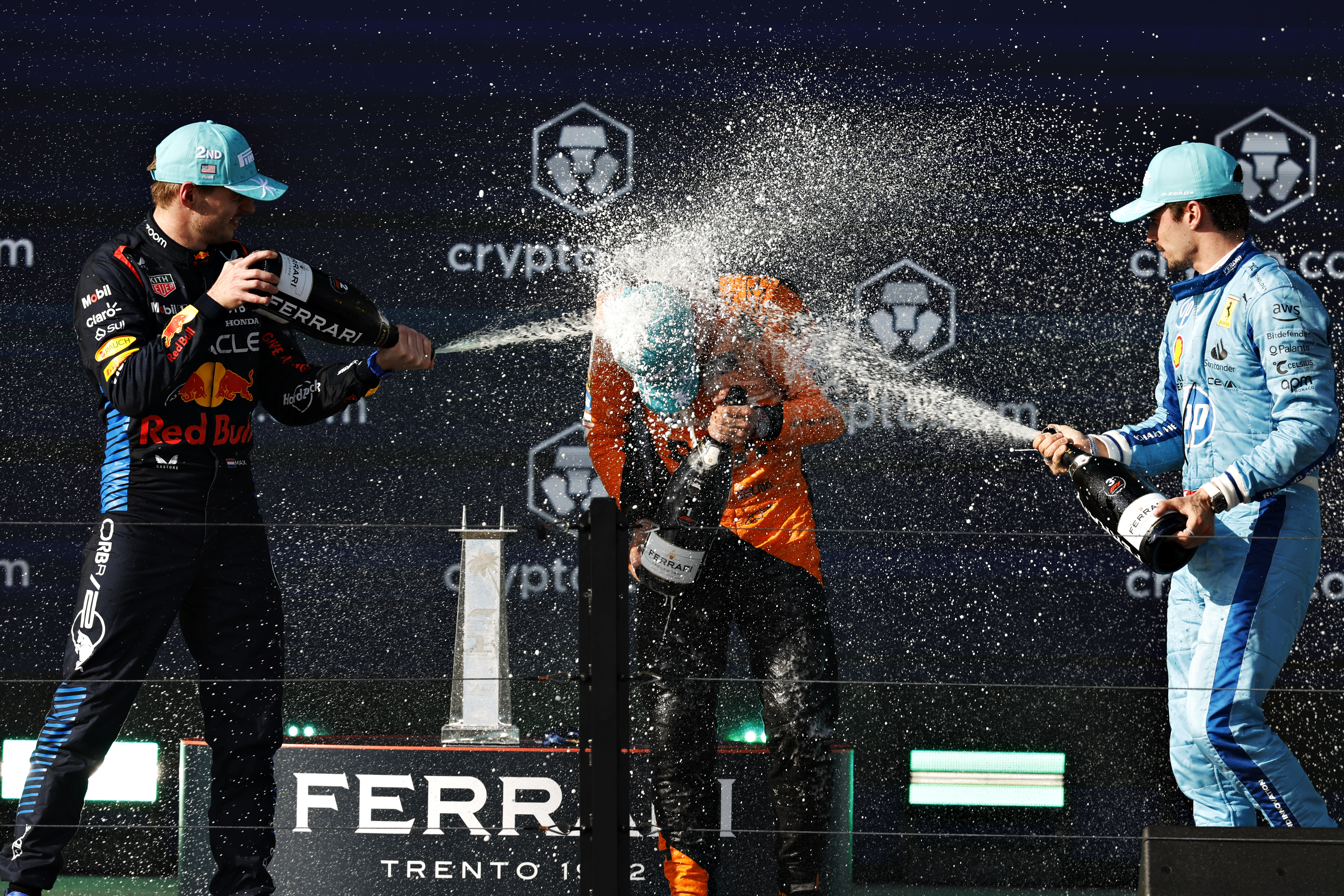 Max Verstappen, Lando Norris, and Charles Leclerc Podium Celebration HD Wallpaper