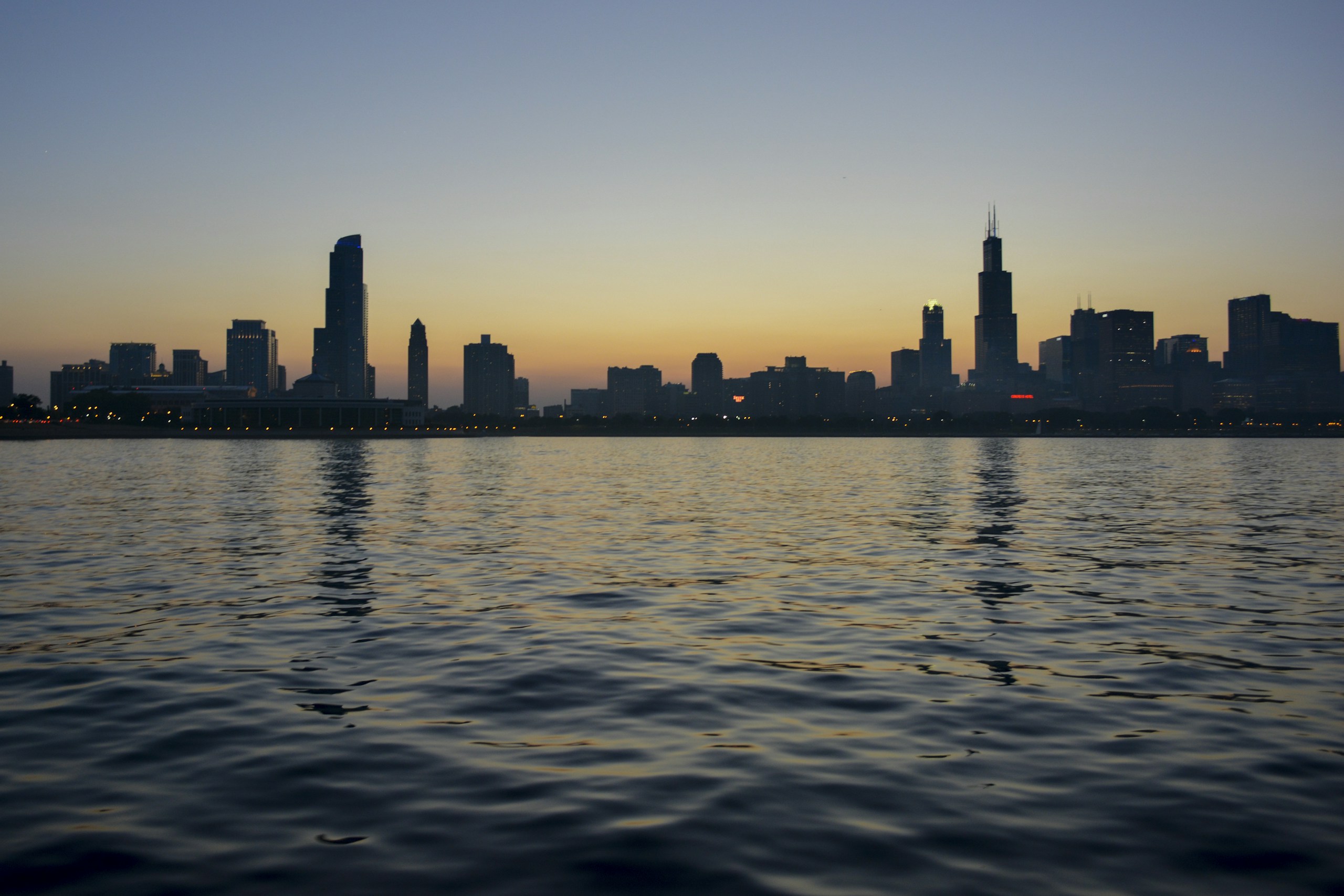Chicago skyline silhouette from Lake Michigan at dusk HD Wallpaper