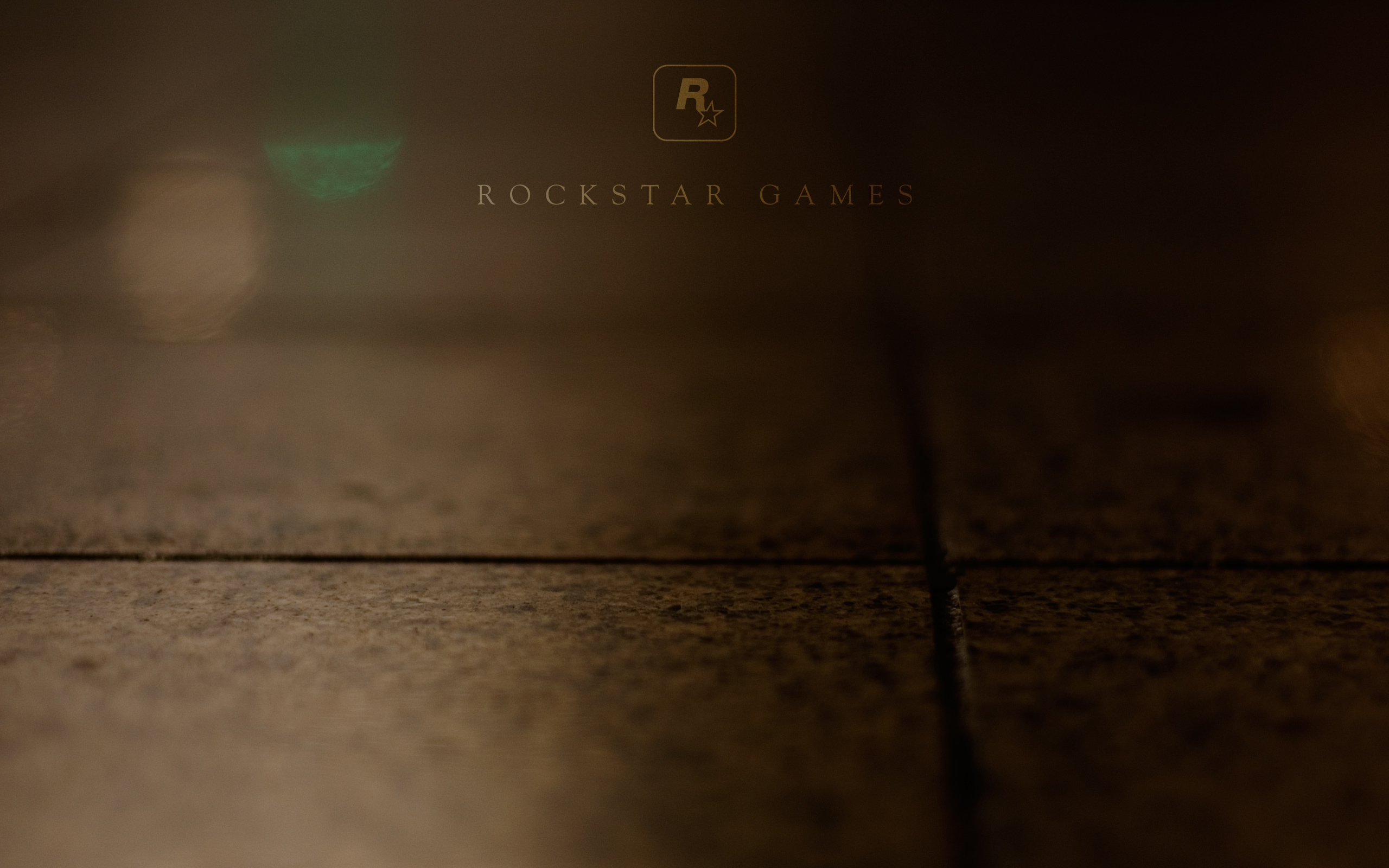 Rockstar Games Logo on Dark Textured Floor HD Wallpaper