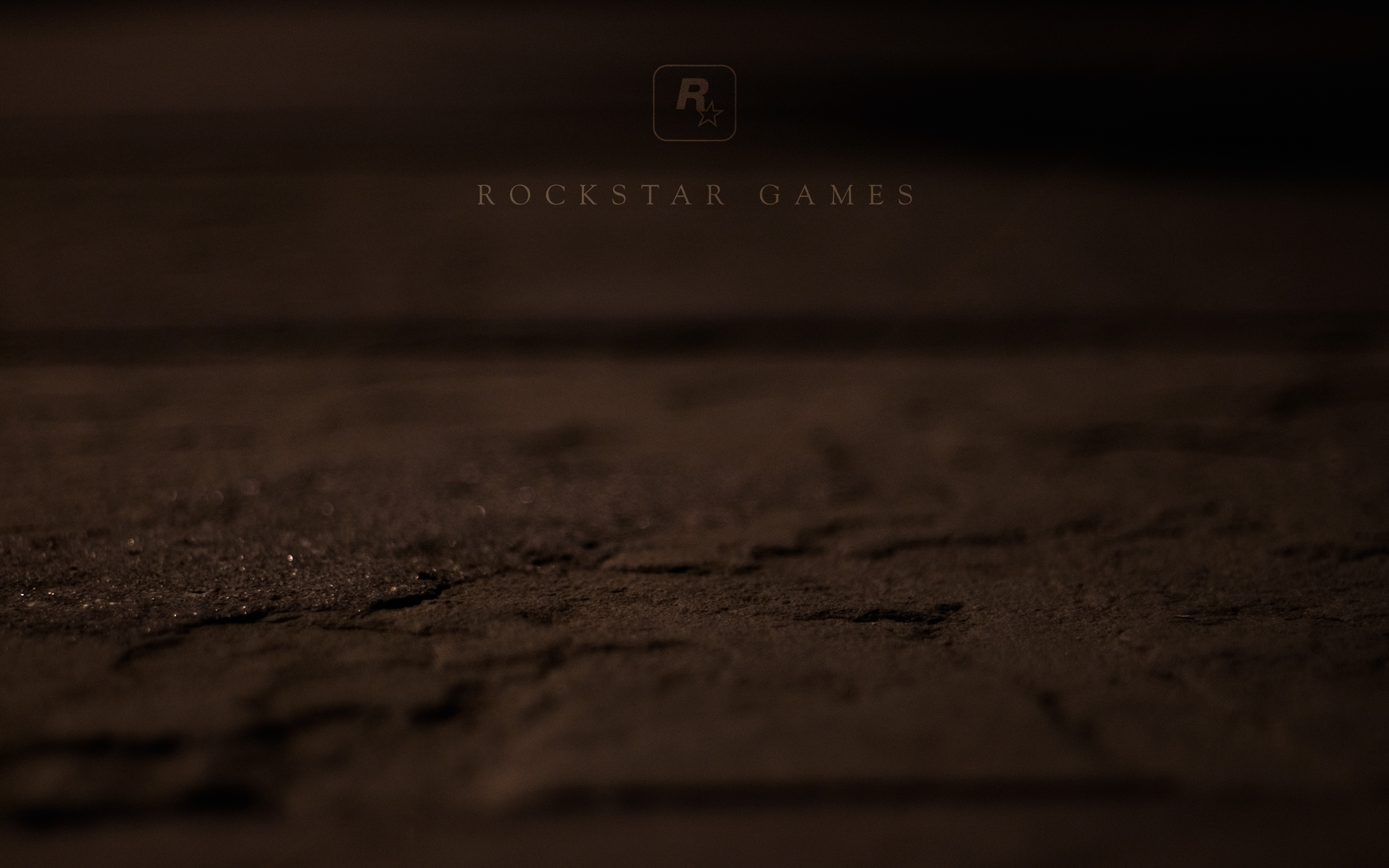Rockstar Games Logo on Dark Textured Ground HD Wallpaper
