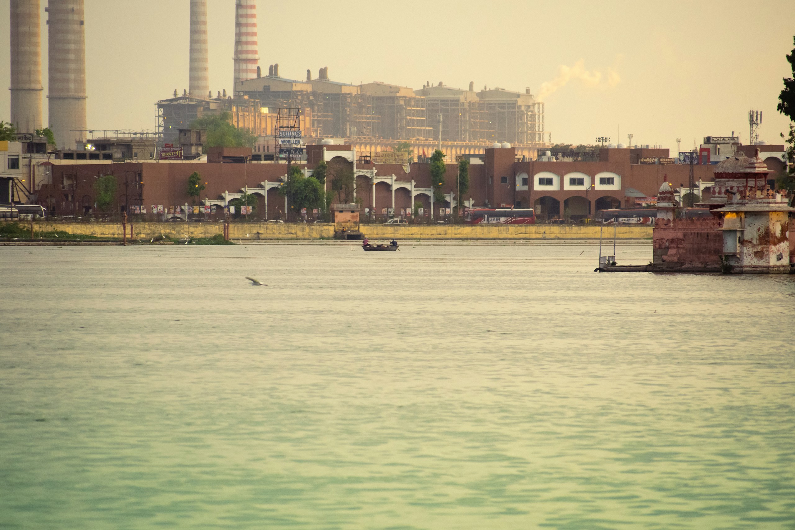 Boat on a lake with industrial background HD Wallpaper