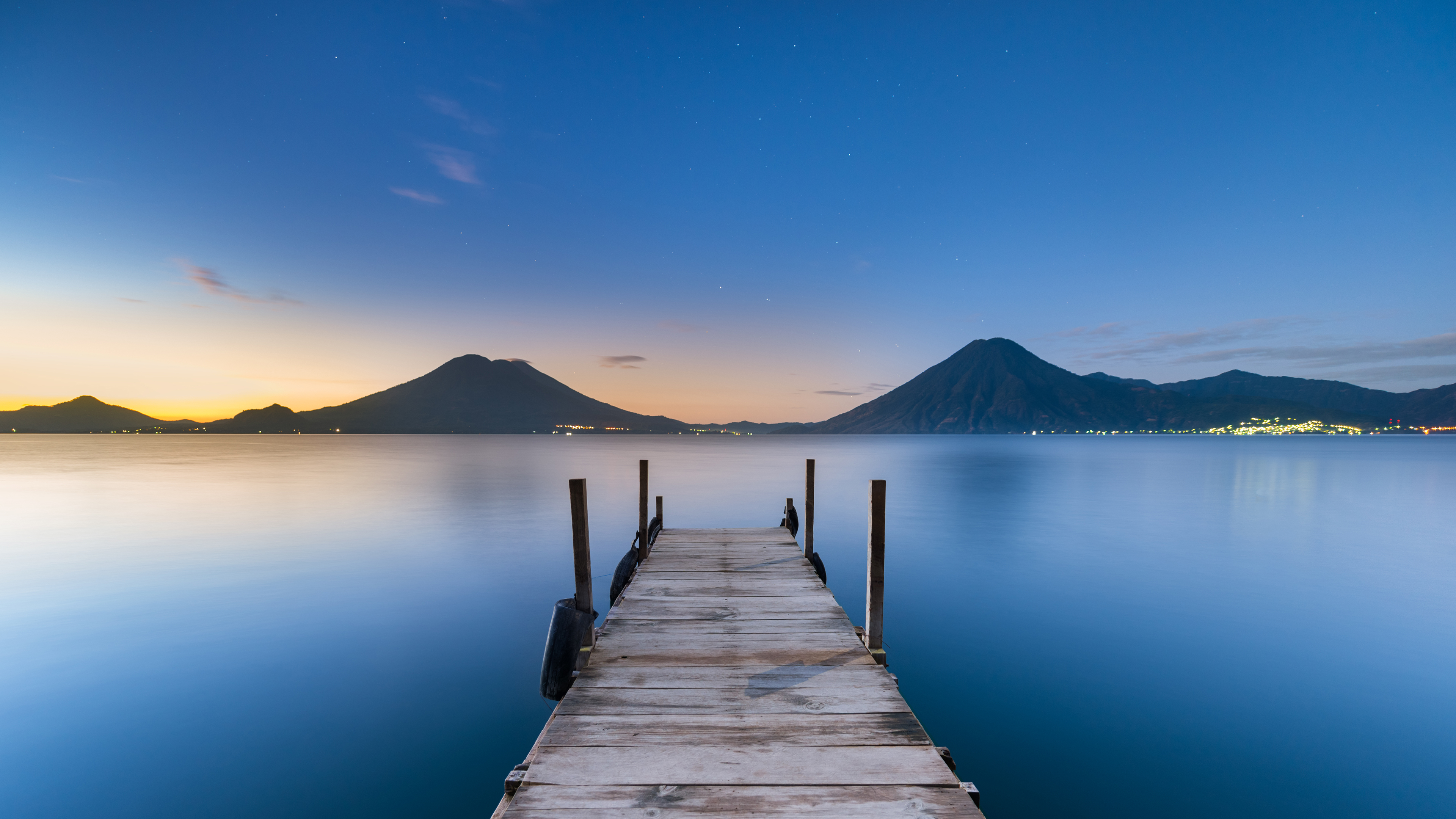 Wooden pier on Lake Atitlan with volcanoes at twilight HD Wallpaper