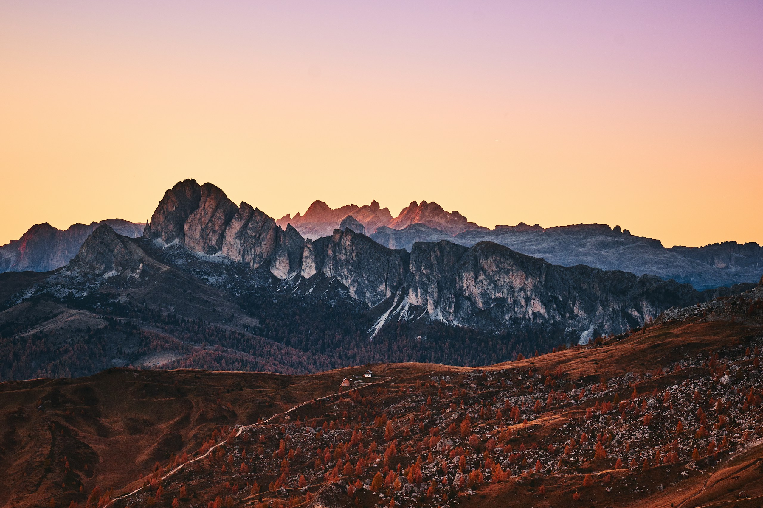 Mountain range during sunset with autumn trees HD Wallpaper