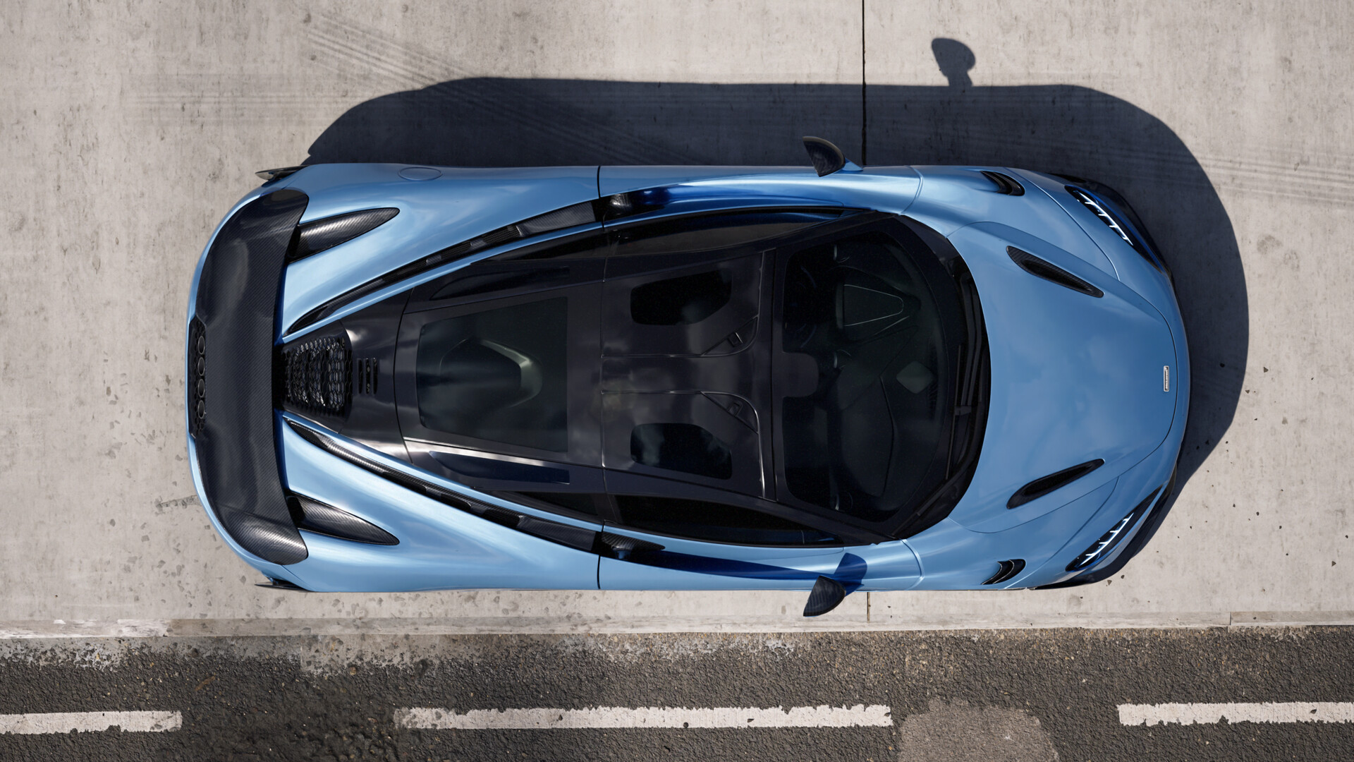 Top-down view of a light blue McLaren sports car HD Wallpaper