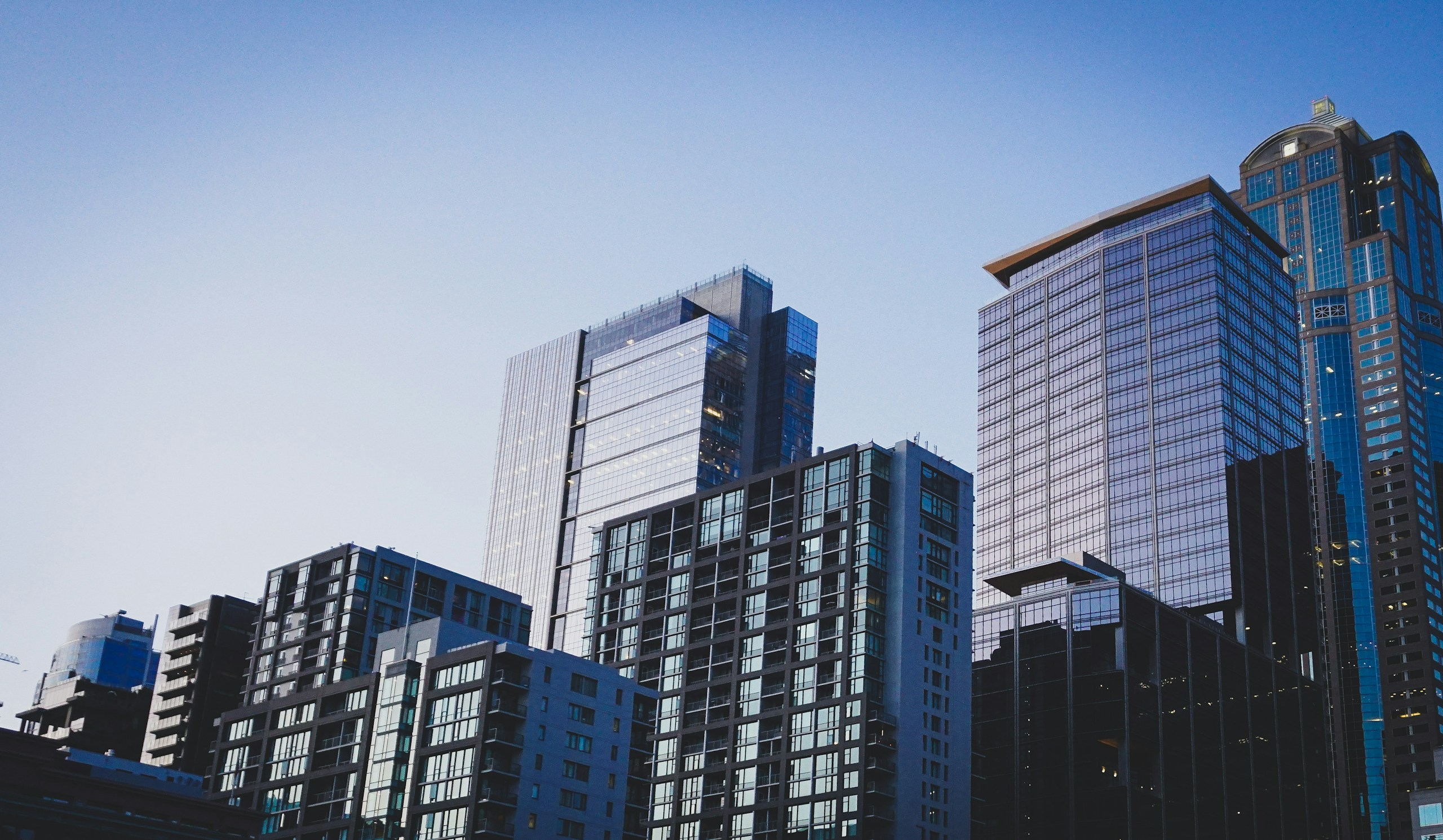 Modern glass skyscrapers in downtown city skyline HD Wallpaper