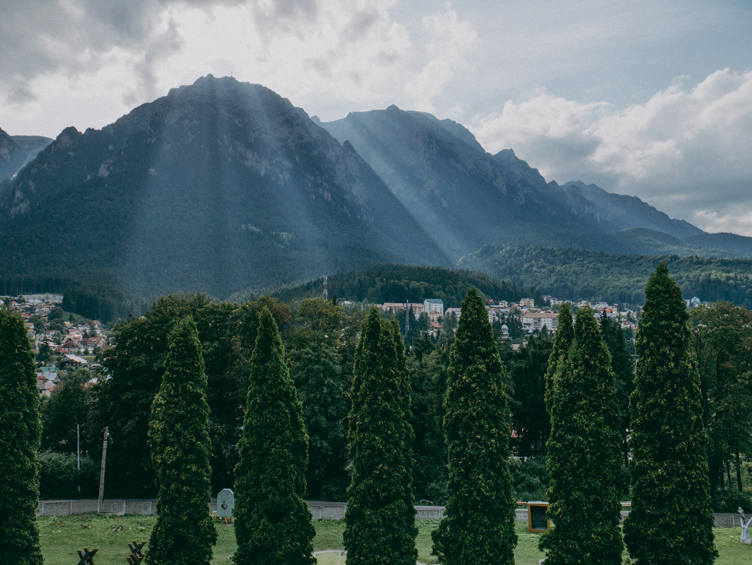 Sunbeams over Carpathian Mountains and Romanian Town HD Wallpaper