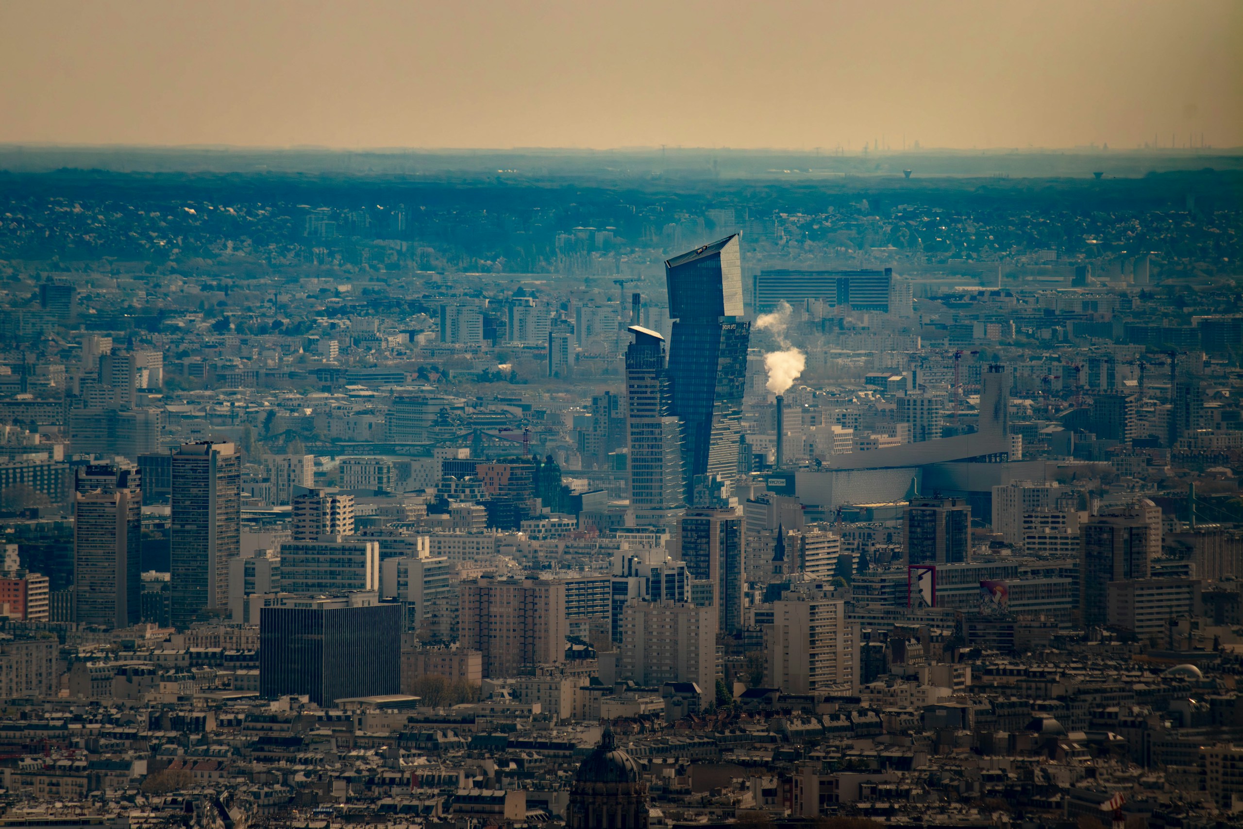 Aerial view of the dense Paris cityscape featuring Tours Duo HD Wallpaper