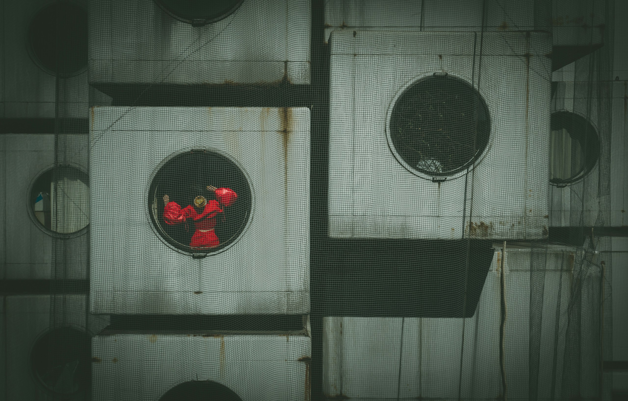 Person in red inside Nakagin Capsule Tower HD Wallpaper