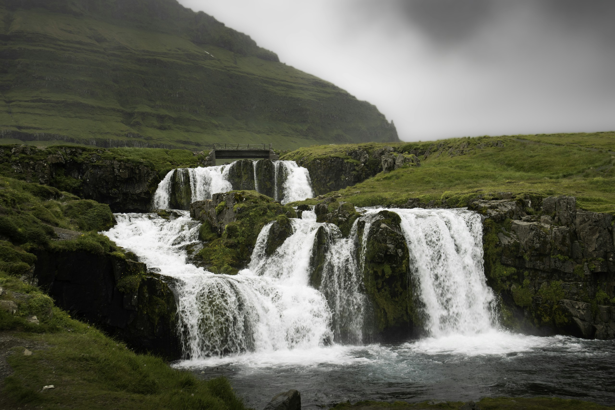 Kirkjufellsfoss waterfall in a green valley HD Wallpaper