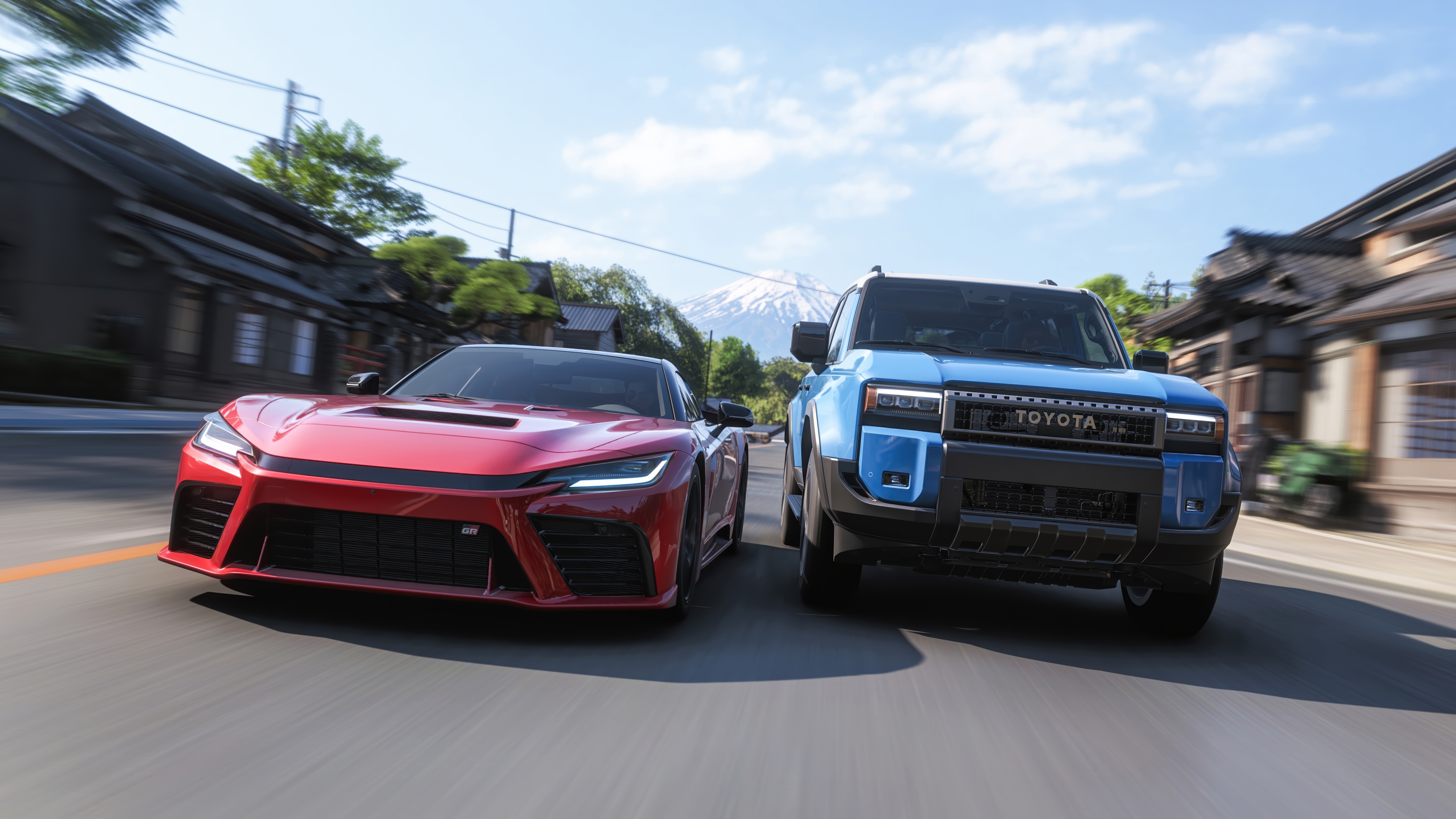 Red Toyota GR Sports Car and Blue Toyota Land Cruiser HD Wallpaper