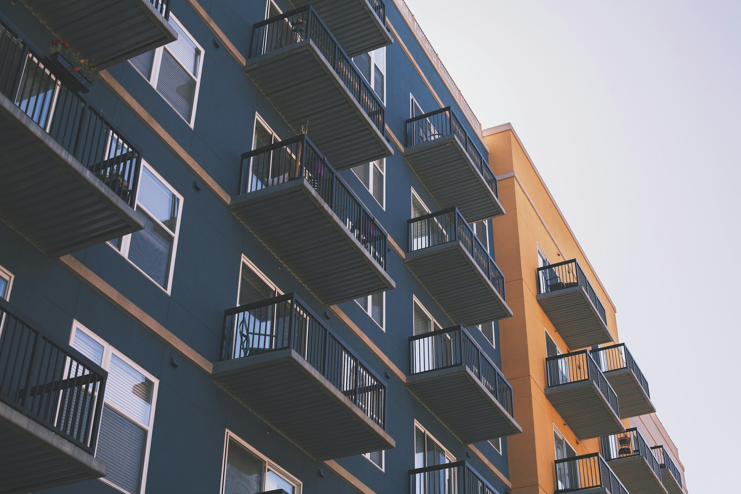 Low Angle View of Blue and Orange Apartment Building HD Wallpaper