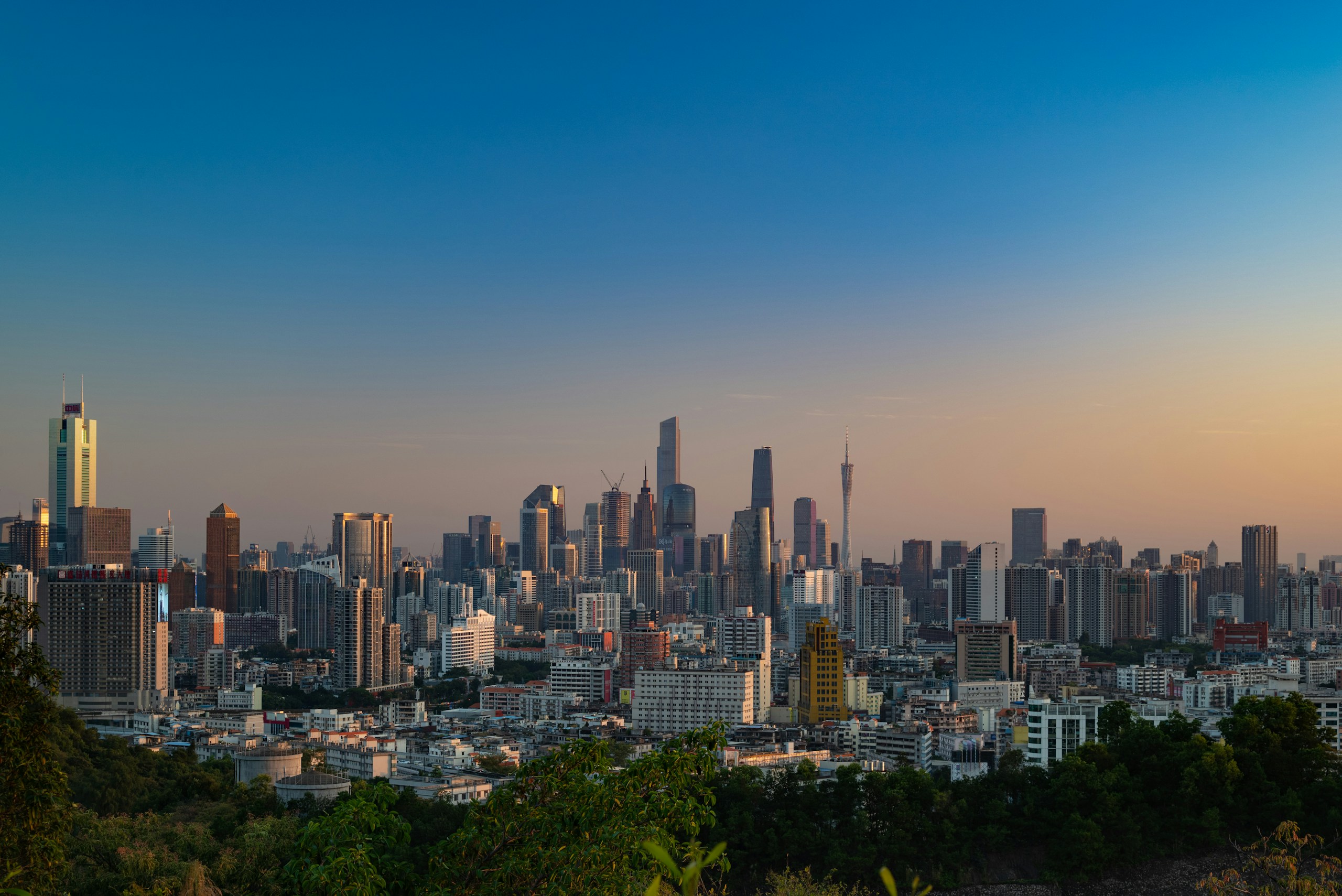 Guangzhou City Skyline Viewed from a Hill at Sunset HD Wallpaper
