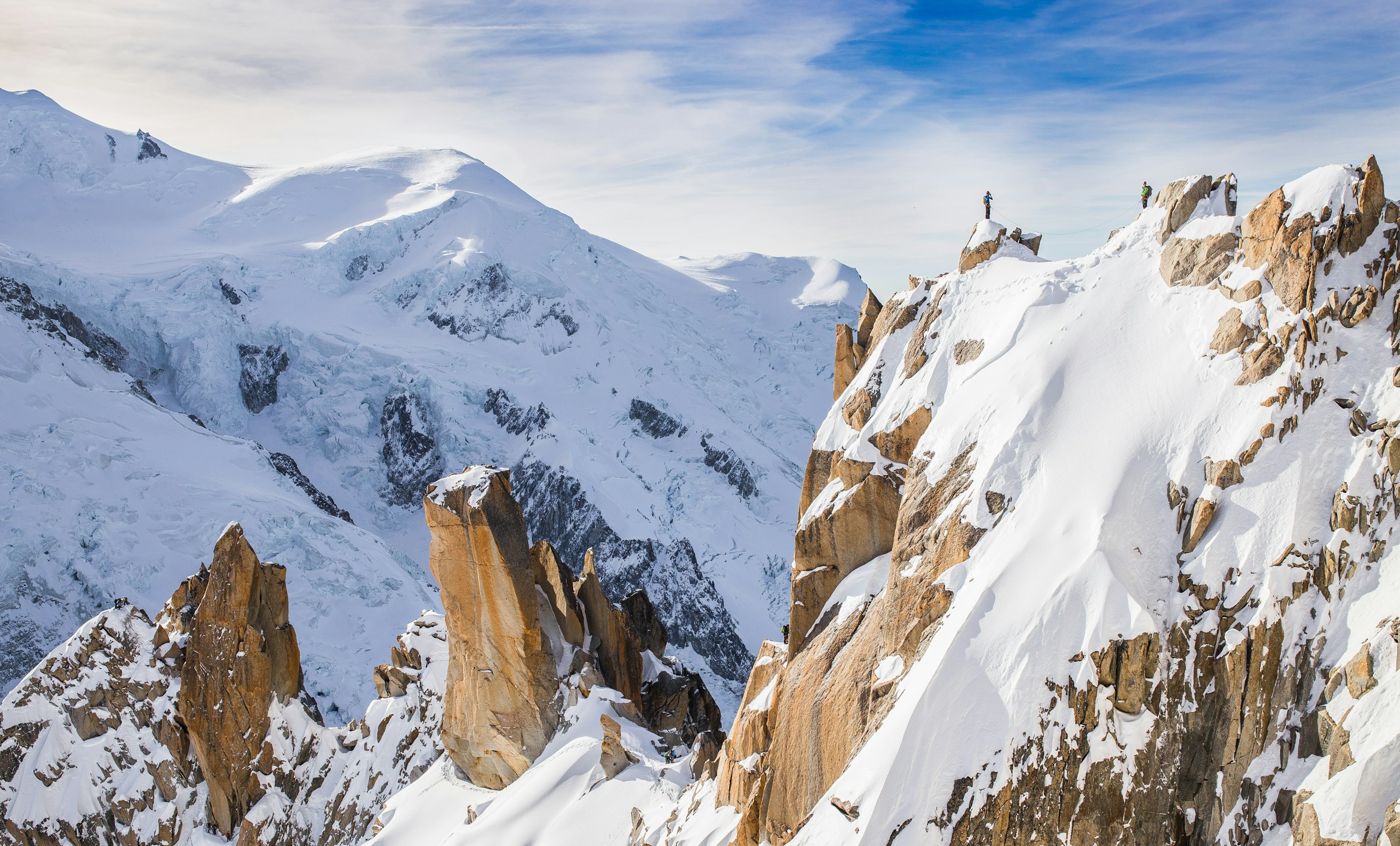 Mountaineers on a snowy ridge in the Alps HD Wallpaper