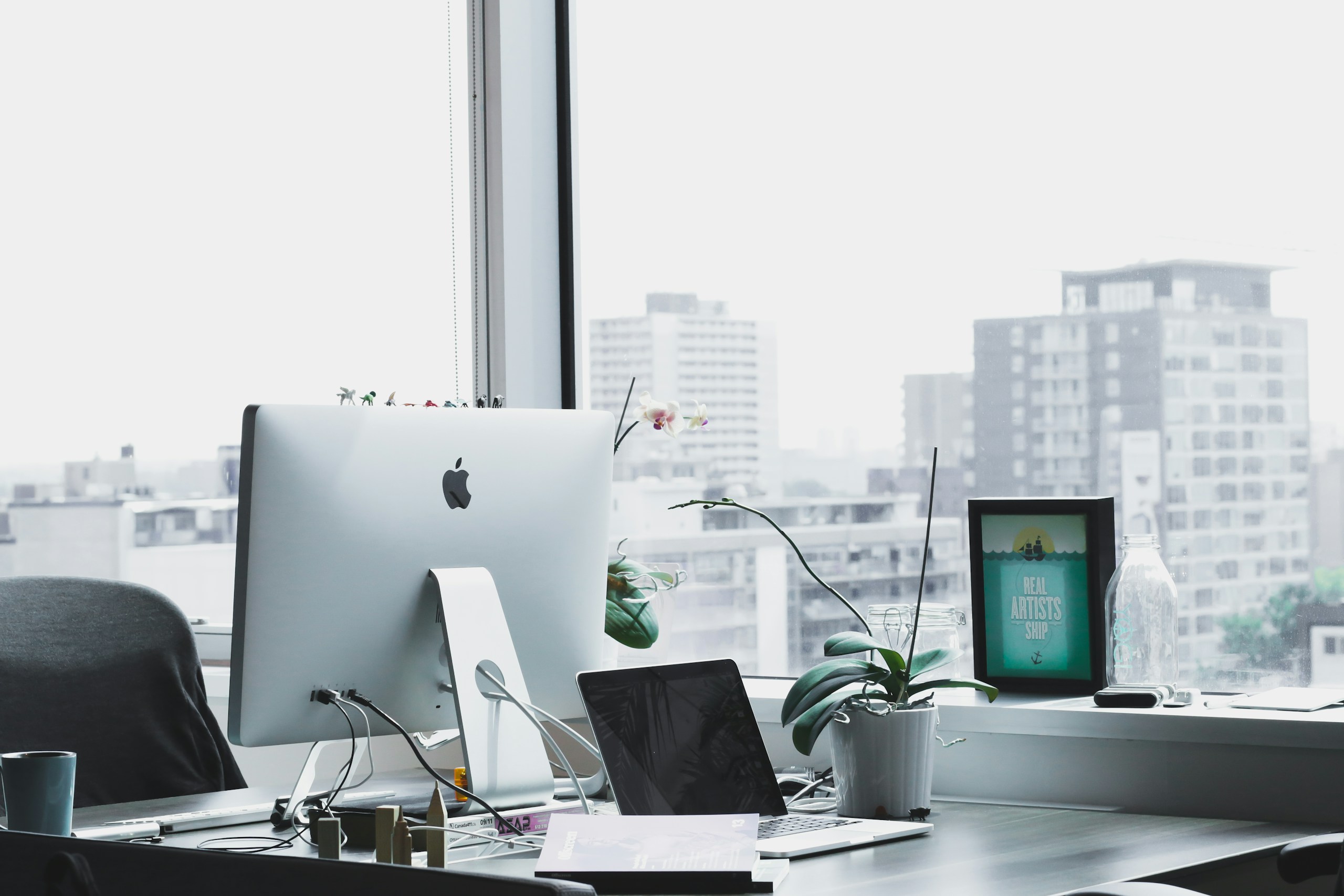 Modern Office Desk Setup with iMac and City View HD Wallpaper