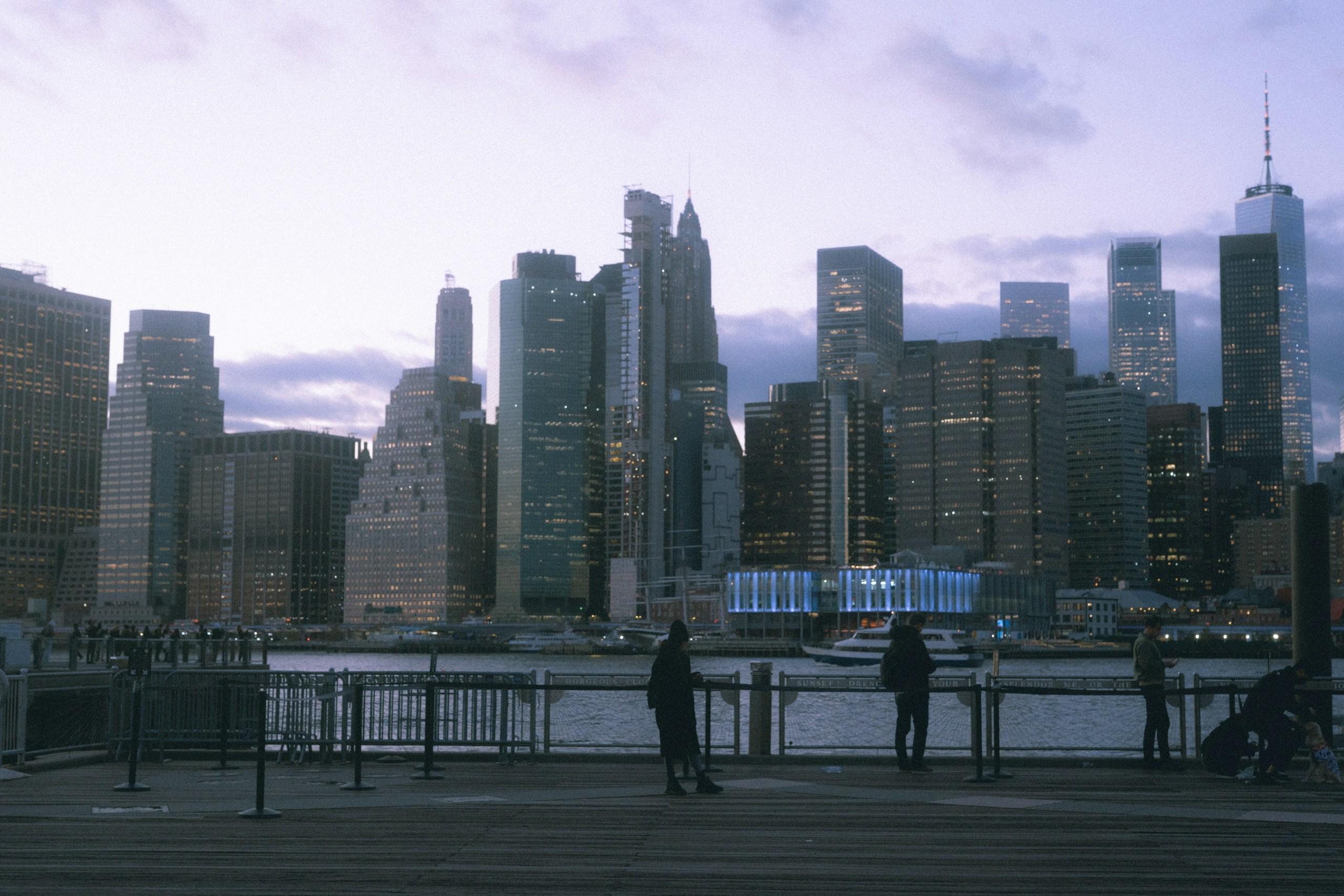 People on a pier overlooking the Manhattan skyline HD Wallpaper