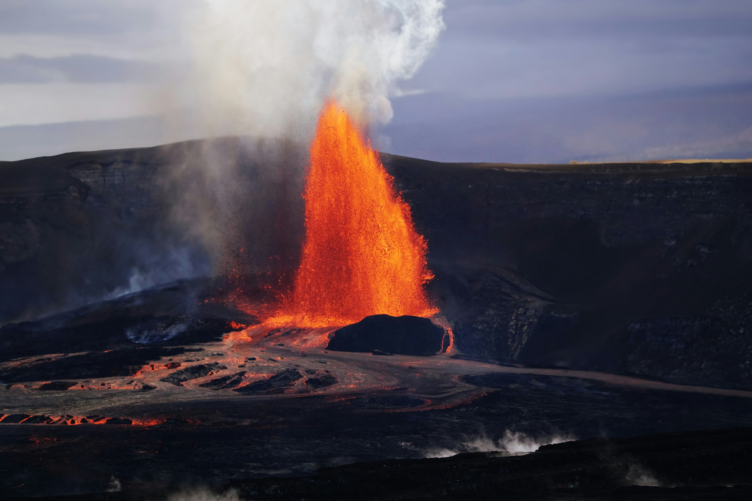 Volcanic eruption with bright orange lava fountain HD Wallpaper
